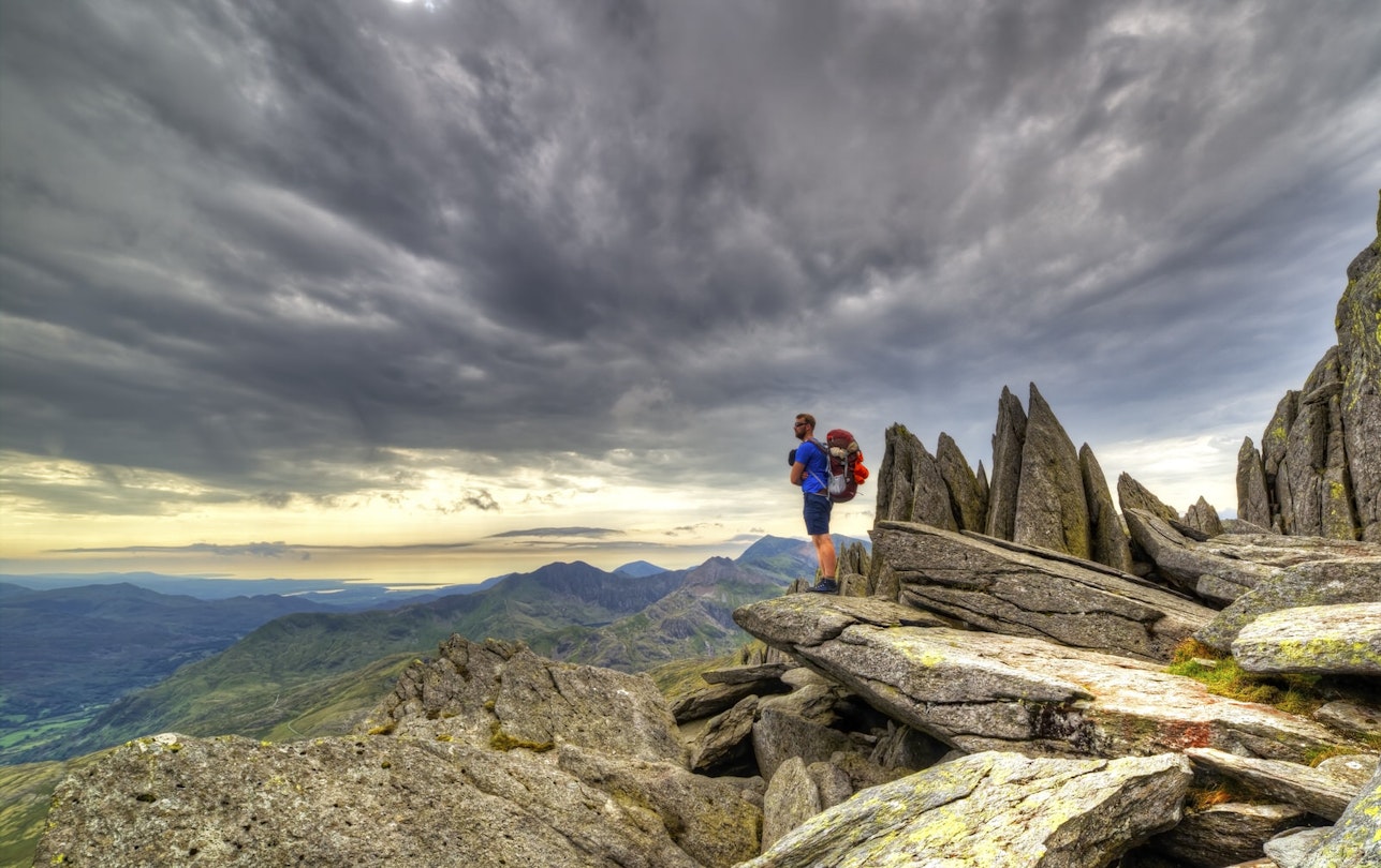A hiker surveys Snowdonia from Glyder Fach © Sebastien Coell / Shutterstock