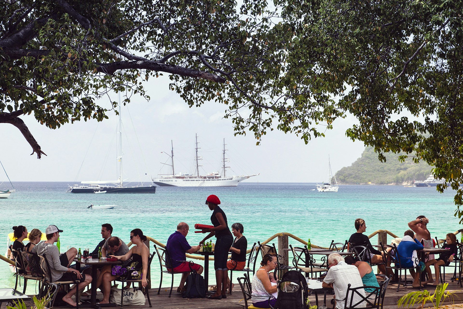 Patrons dine at a beach-side cafe near Lower Bay © Walter Bibikow / Getty Images