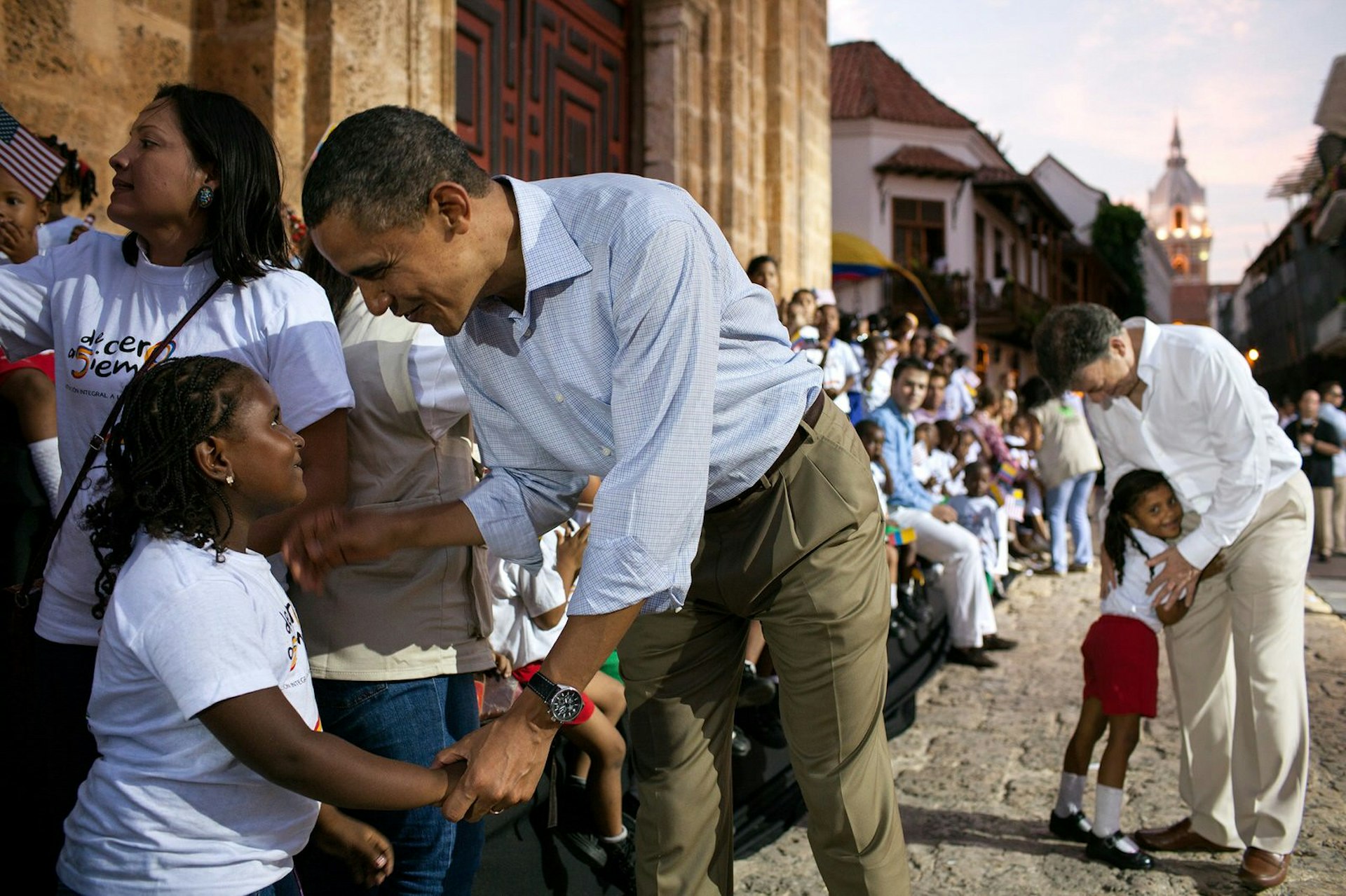 President Obama greeting a young girl at the Plaza de San Pedro, Cartagena, Colombia, during the Summit of the Americas, April 15, 2012 © Pete Souza / Official White House Photo