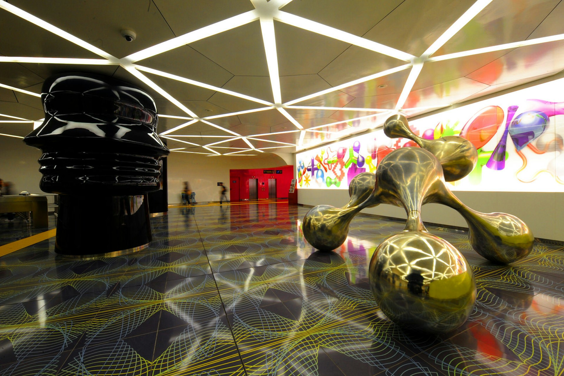 People walk in the University subway station with artworks of Egyptian artist Karim Rashid as part of the "Art Station Line 1" project on November 5, 2012 in Naples. AFP PHOTO / MARIO LAPORTA (Photo credit should read MARIO LAPORTA/AFP/Getty Images)