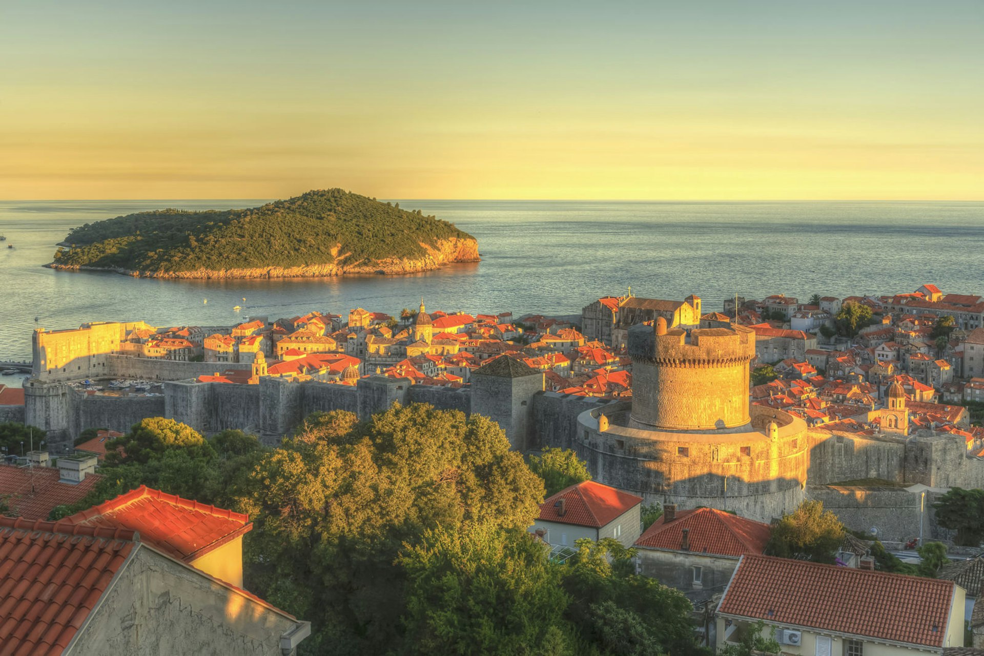 Dubrovnik's Old Town and Lokrum Island glow in the light of the setting sun 