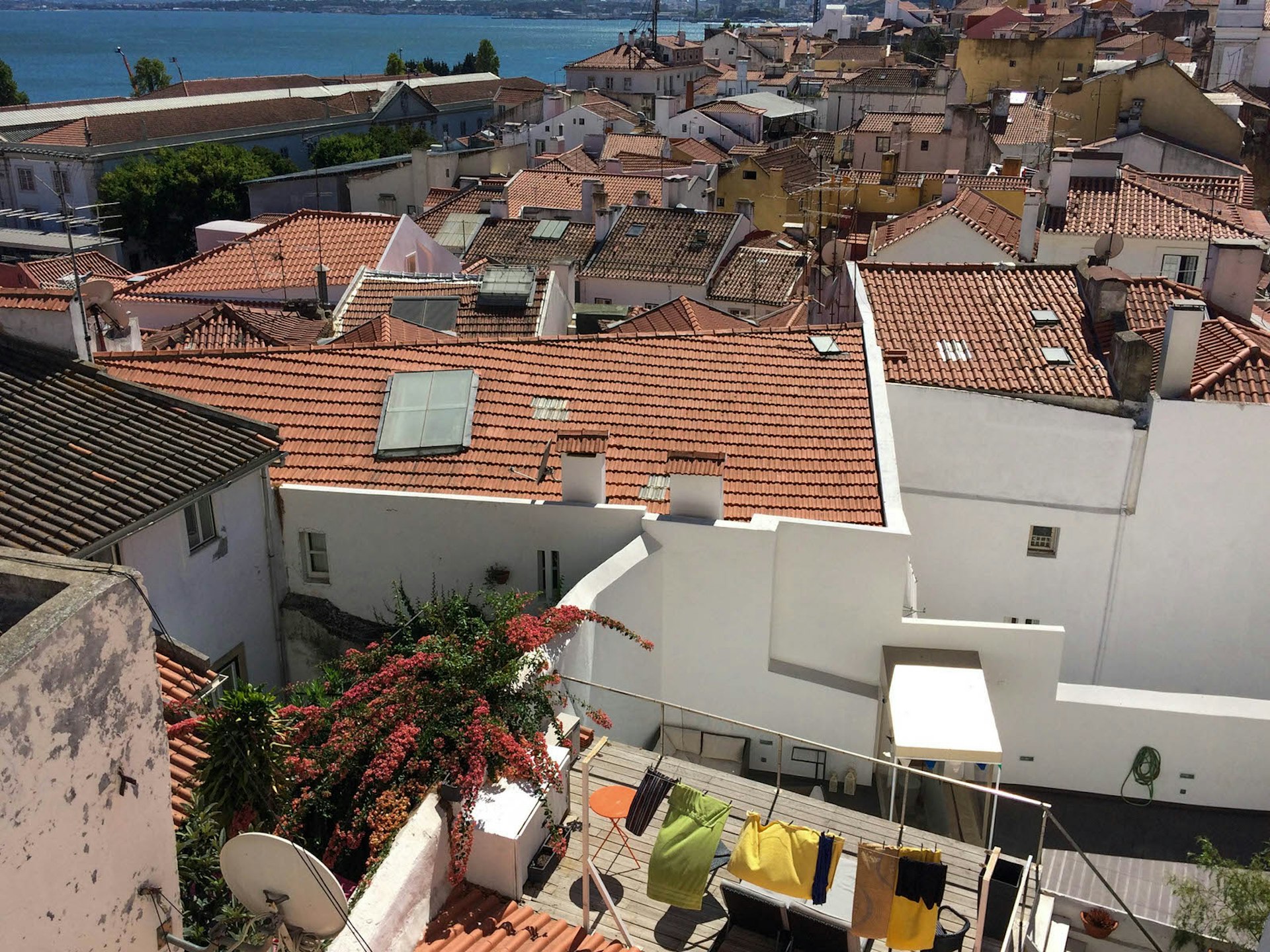 View over sunbathed patios and terracotta rooftops