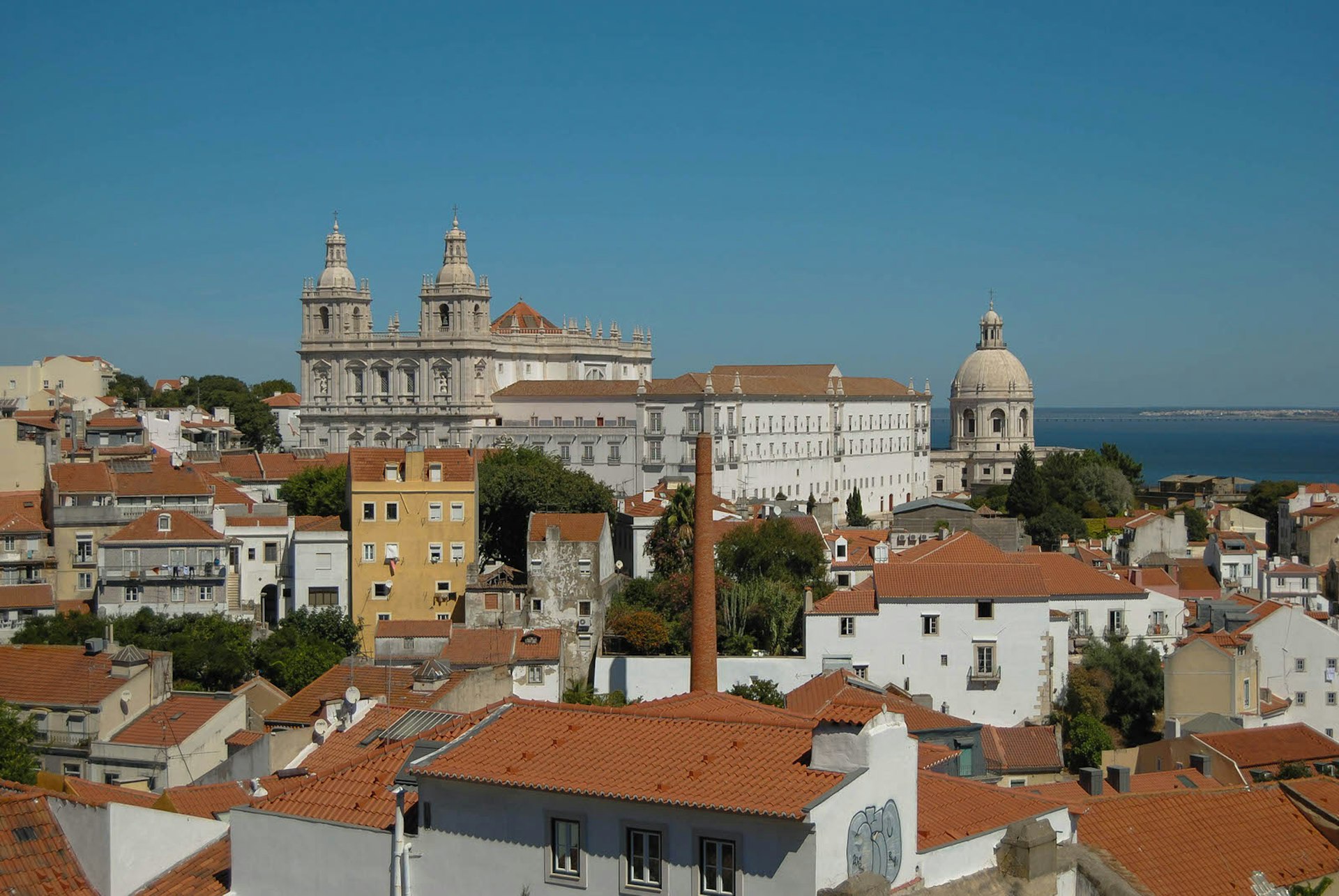 View over terracotta rooftops to the Igreja de São Vicente de Fora from the Miradouro do Recolhimento