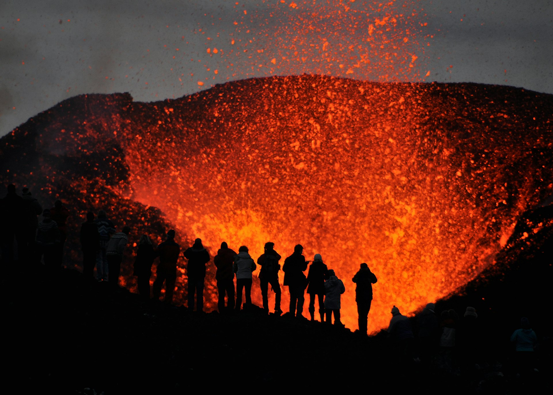 A group of adventurers witnessing the eruption of Iceland's Eyjafjallajökull, one of three volcanoes which the Lava Centre's viewing platform overlooks © TrueCapture / Getty Images