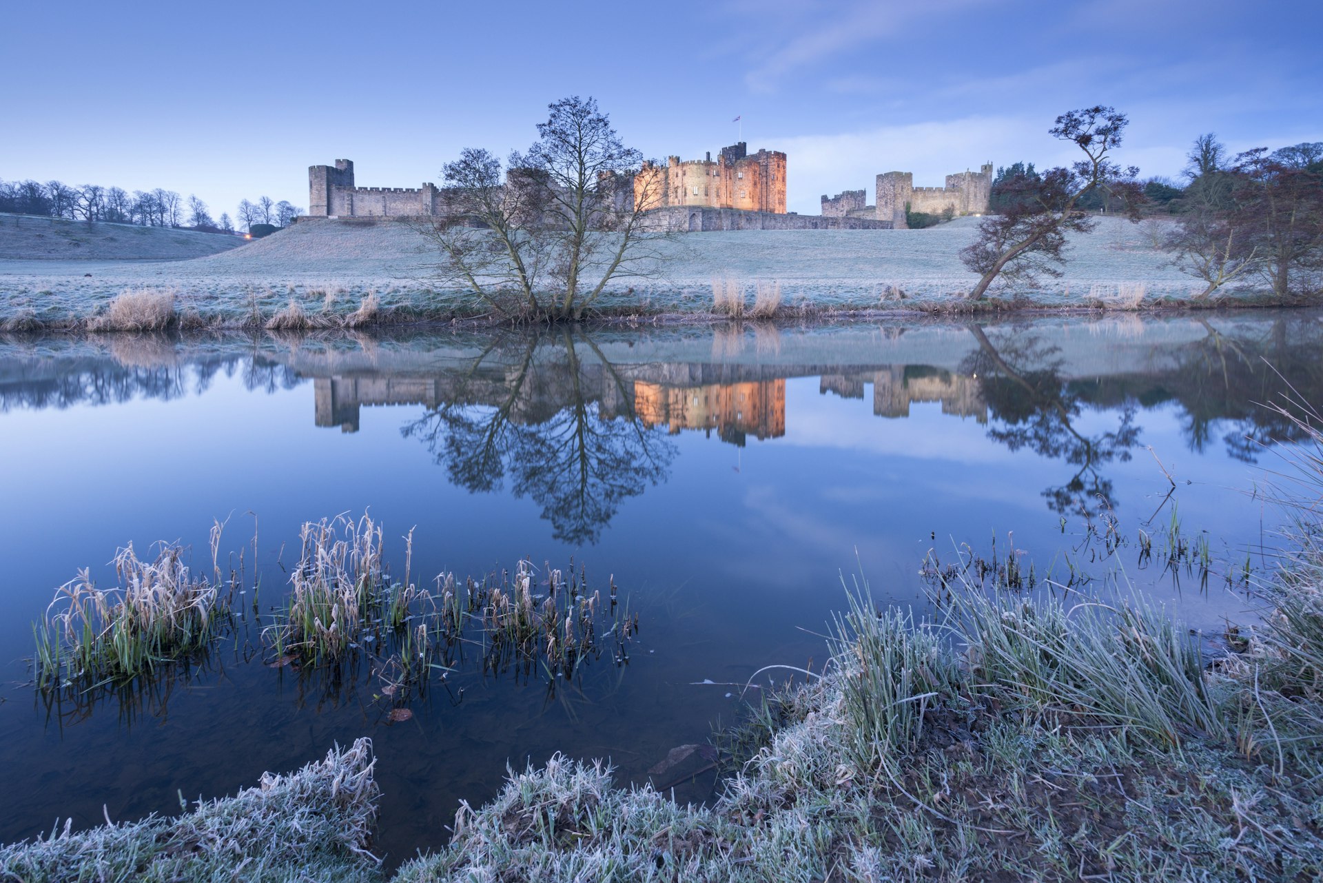 Alnwick Castle reflected in the River Aln © Adam Burton / Robert Harding / Getty Images