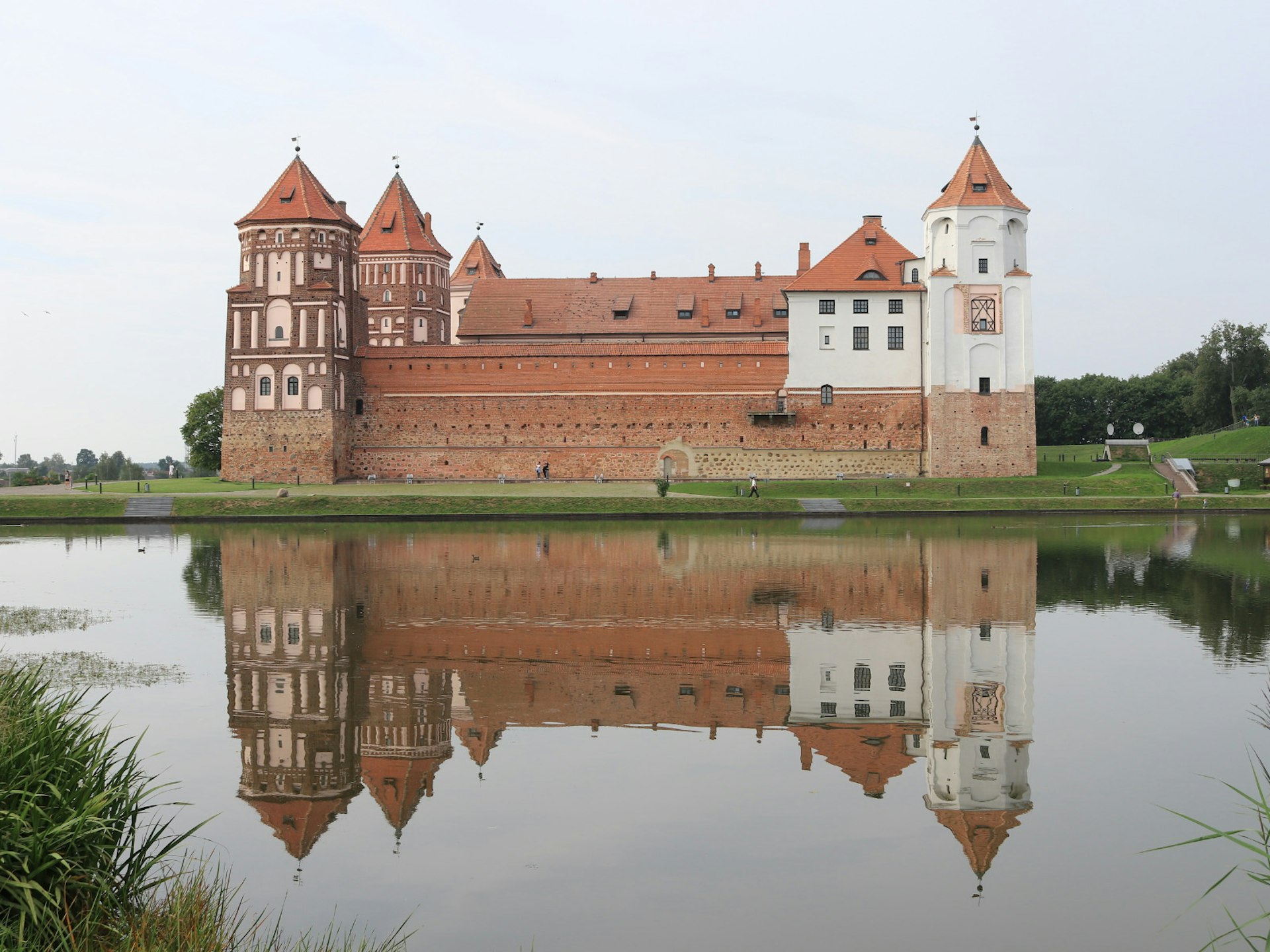 Mir Castle perfectly reflected in a tranquil pond © Greg Bloom / Lonely Planet