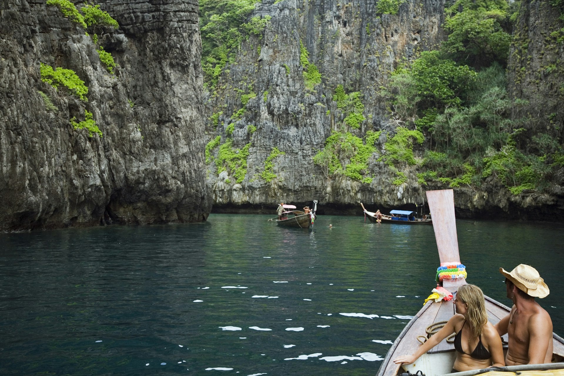 Cruising through the cliffs of Ko Phi Phi Leh in a long-tail boat. Ko Phi Phi Leh, Krabi, Thailand