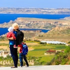 Features - mother with two kids travel on scenic road