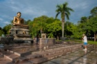 Features - Man praying  at Lord Buddha's Statue ,  Vihara Maha Devi Park, Colombo