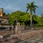 Features - Man praying  at Lord Buddha's Statue ,  Vihara Maha Devi Park, Colombo