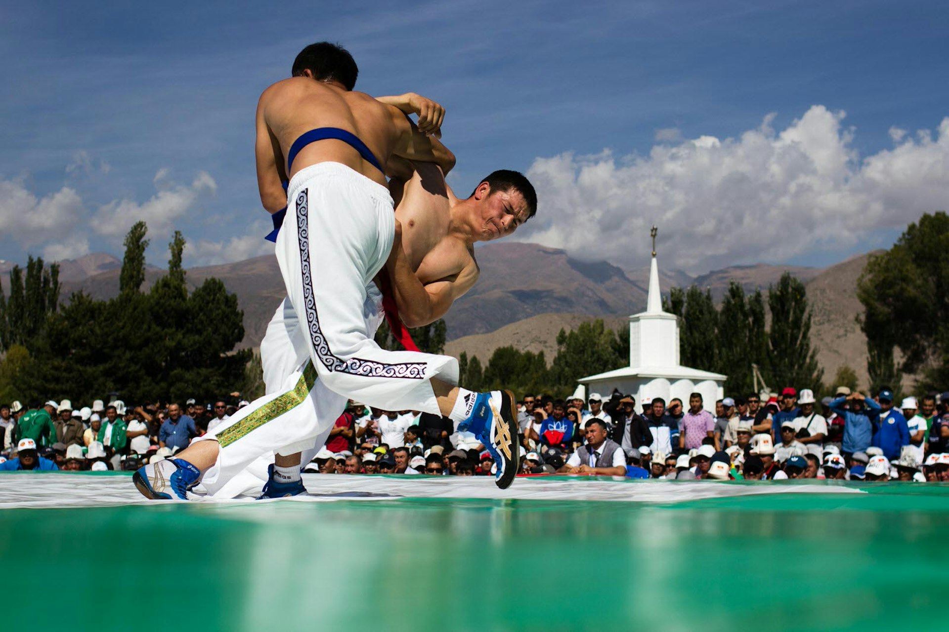 Kyrgyz Kurosh wrestlers fight for the win at the Rukh Ordo complex in Cholpon-Ata during the 2014 World Nomad Games in Kyrgyzstan © Stephen Lioy / Lonely Planet