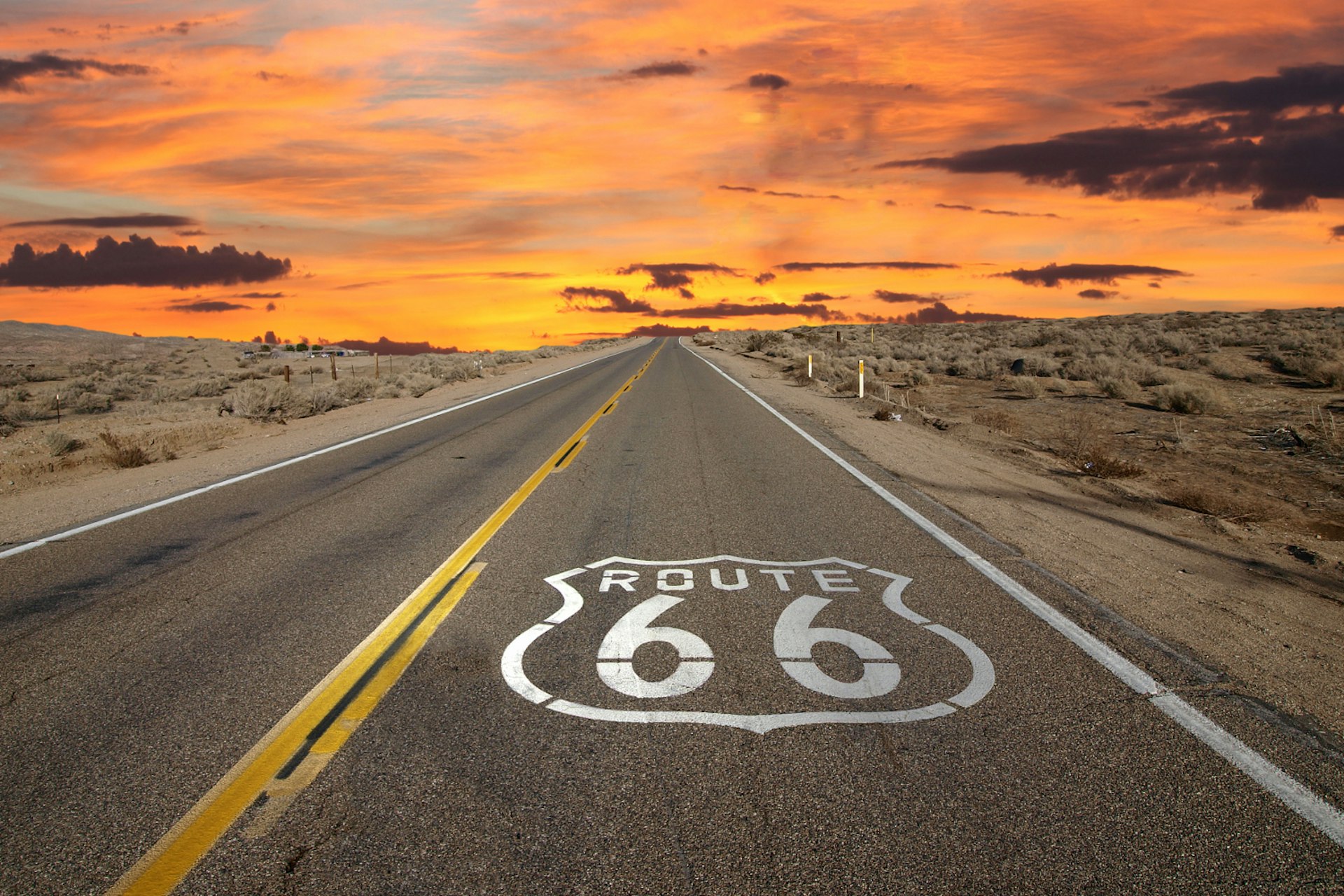 Features - Route 66 pavement sign sunrise in California's Mojave desert.