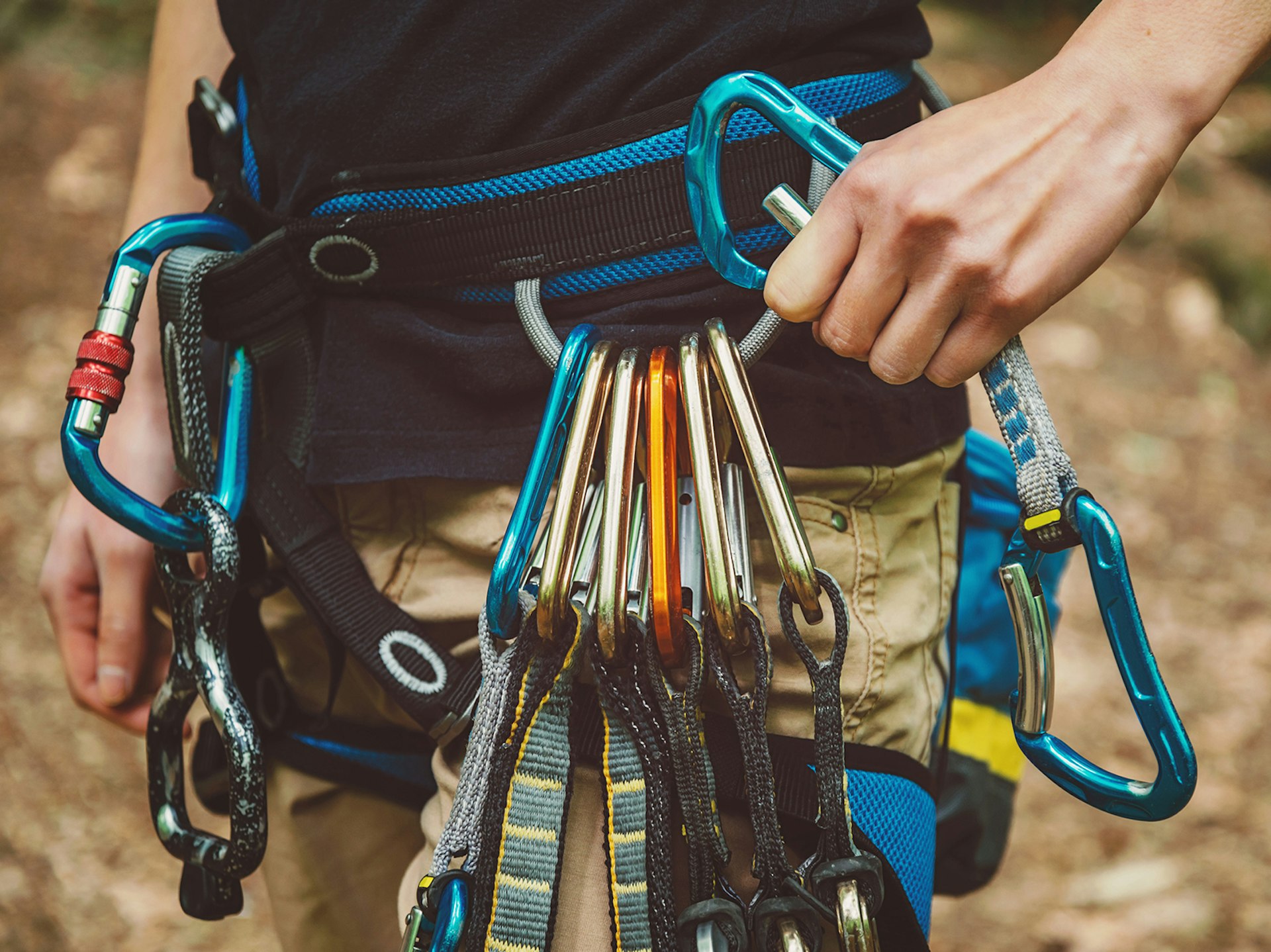 Features - Female rock climber wearing safety harness