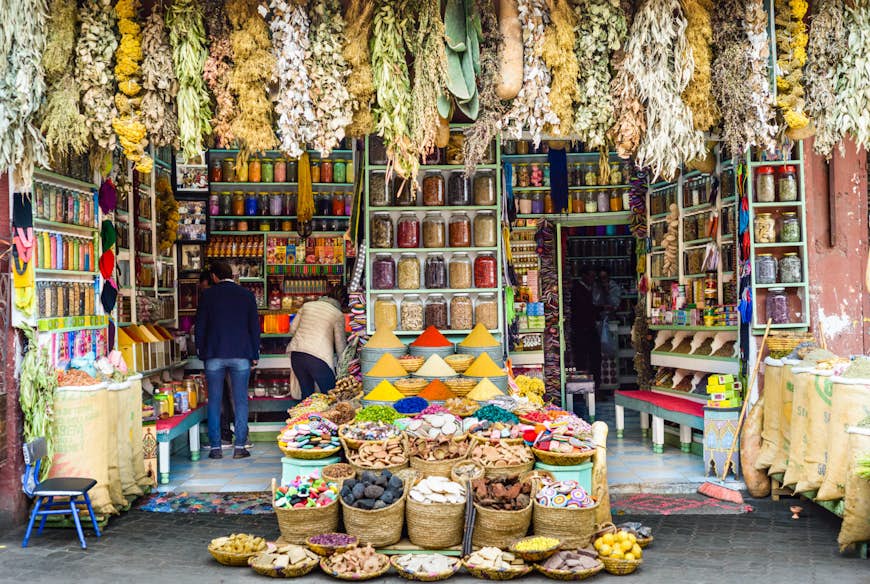 Shoppare tittar på de färgglada lokala produkterna i Marrakech, Marocko © AJ Withey / Getty Images