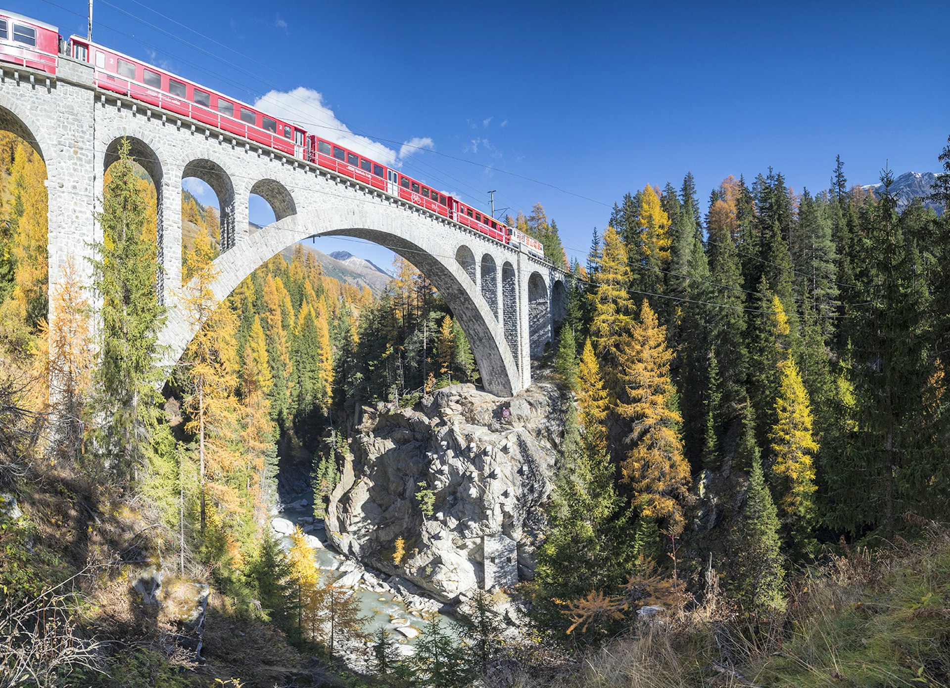 Features - Red train on viaduct Cinuos Chel Switzerland