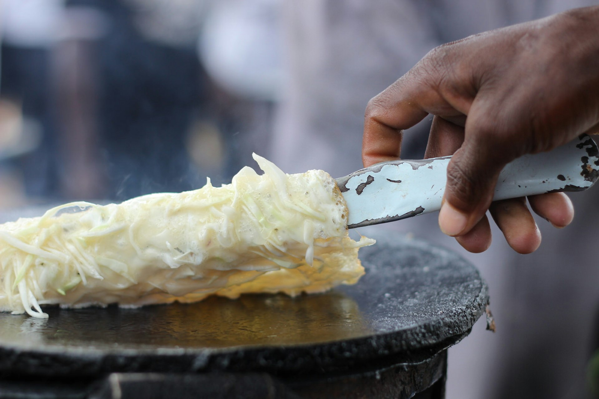 A close up of a 'rolex' – an omelette inside a chapati – being cooked in Uganda © Sarine Arslanian / Shutterstock