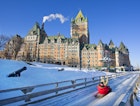 Tobogganers hurtling down the ice in front of Le Château Frontenac © Vlad G / Shutterstock
