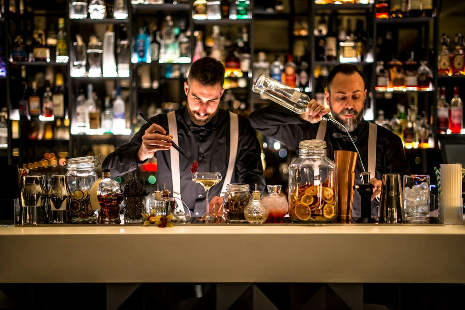 Mixologists attending to their creations
