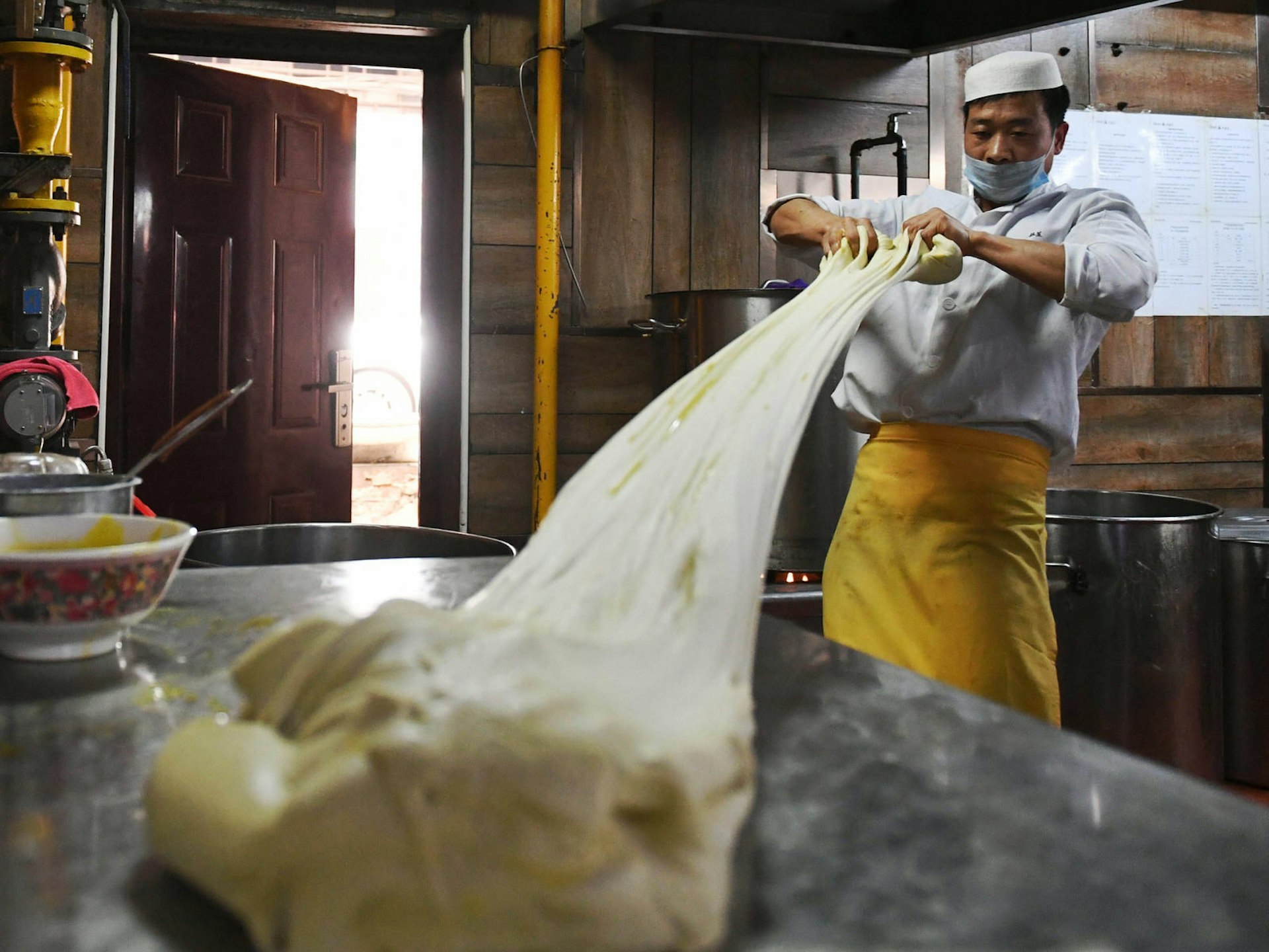 Stretching the dough for Lanzhou's famous lamian noodles © Xinhua News Agency / Getty