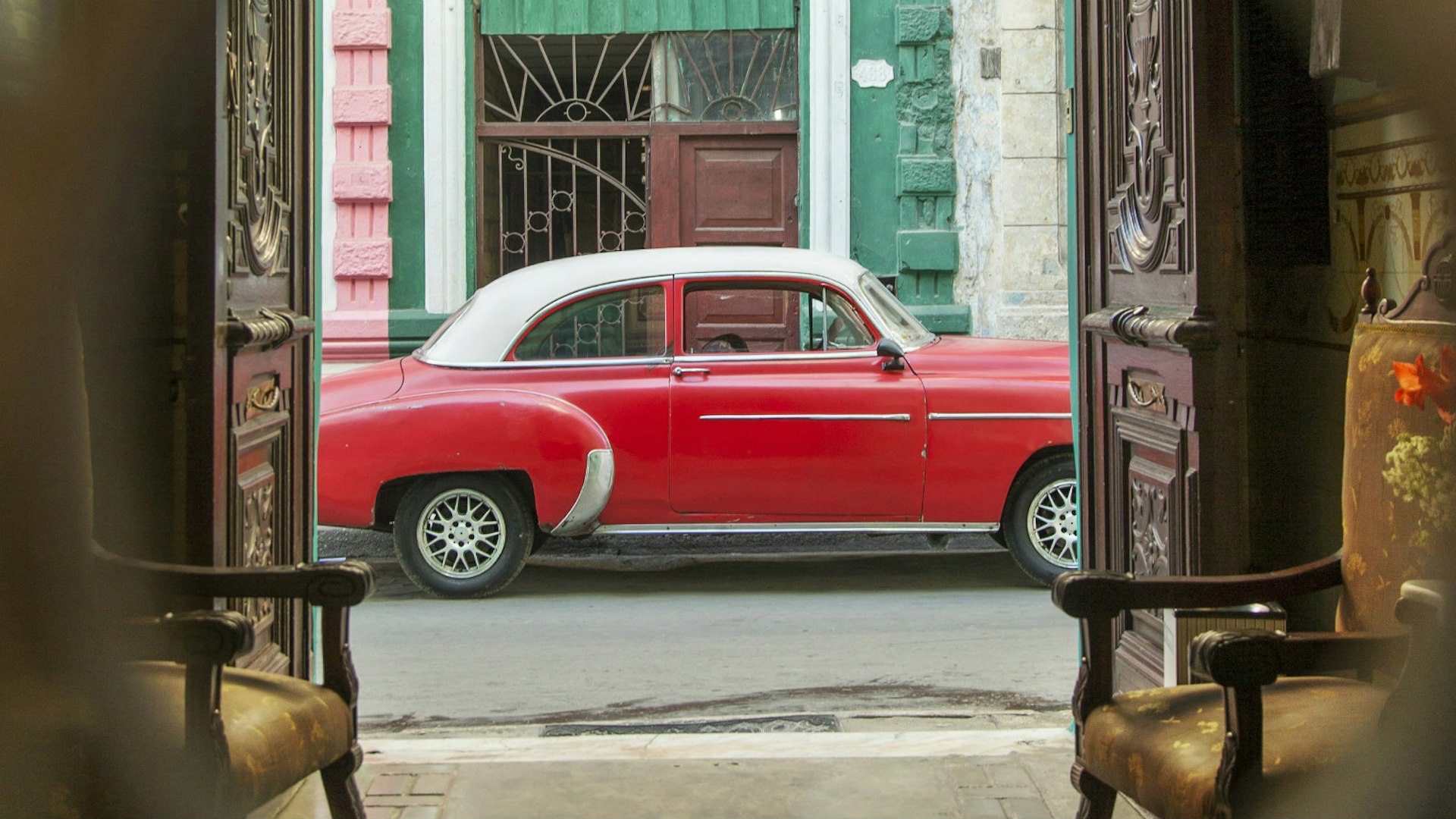 Potent symbols of Cuba adorn the streets of the capital Havana – from classic American cars and crumbling colonial buildings, to cigars and the national flag © Philip Lee Harvey / Lonely Planet
