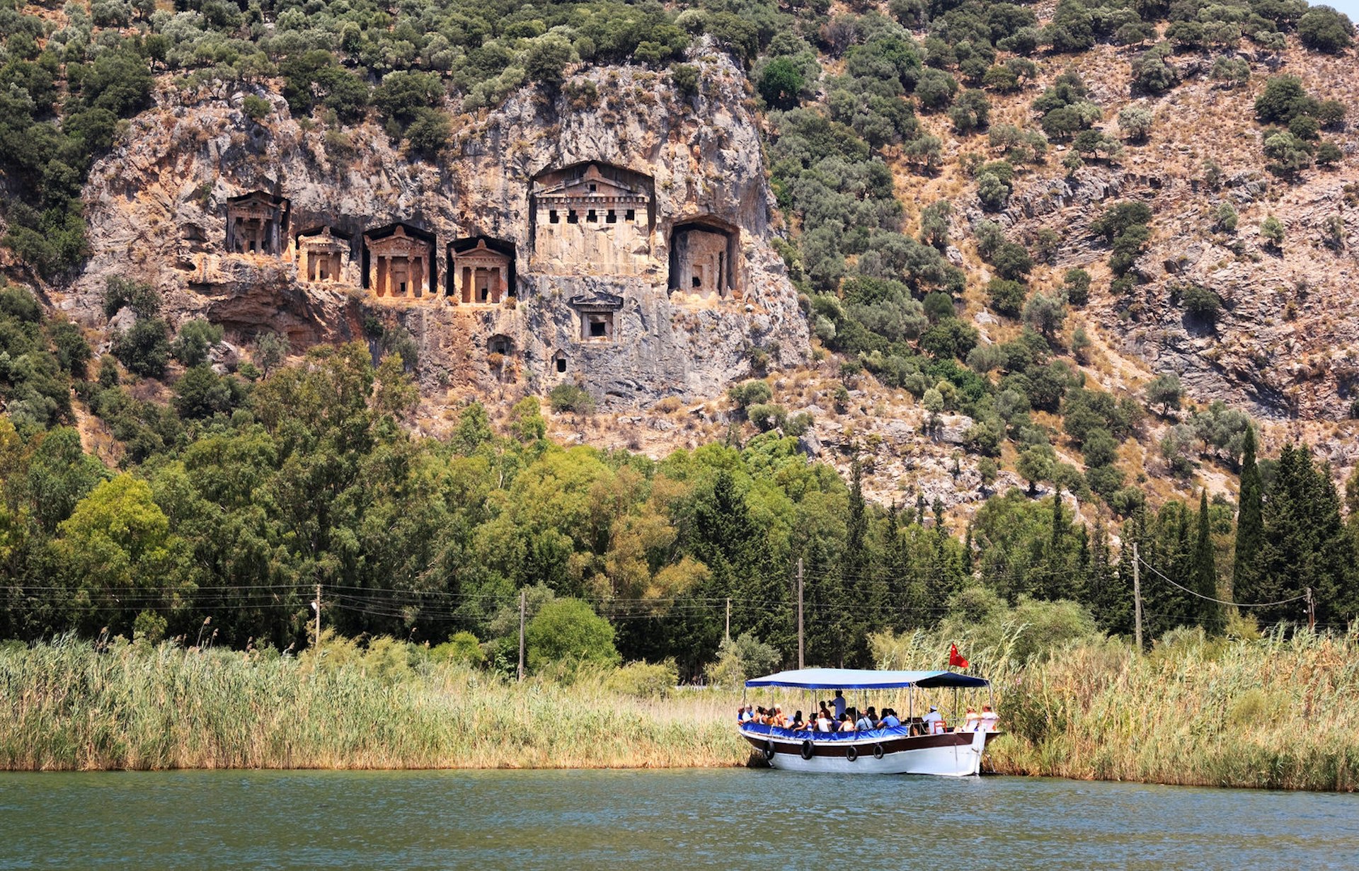 Sailing past the Kings' Tomb on the Dalyan River © Dimos / Shutterstock