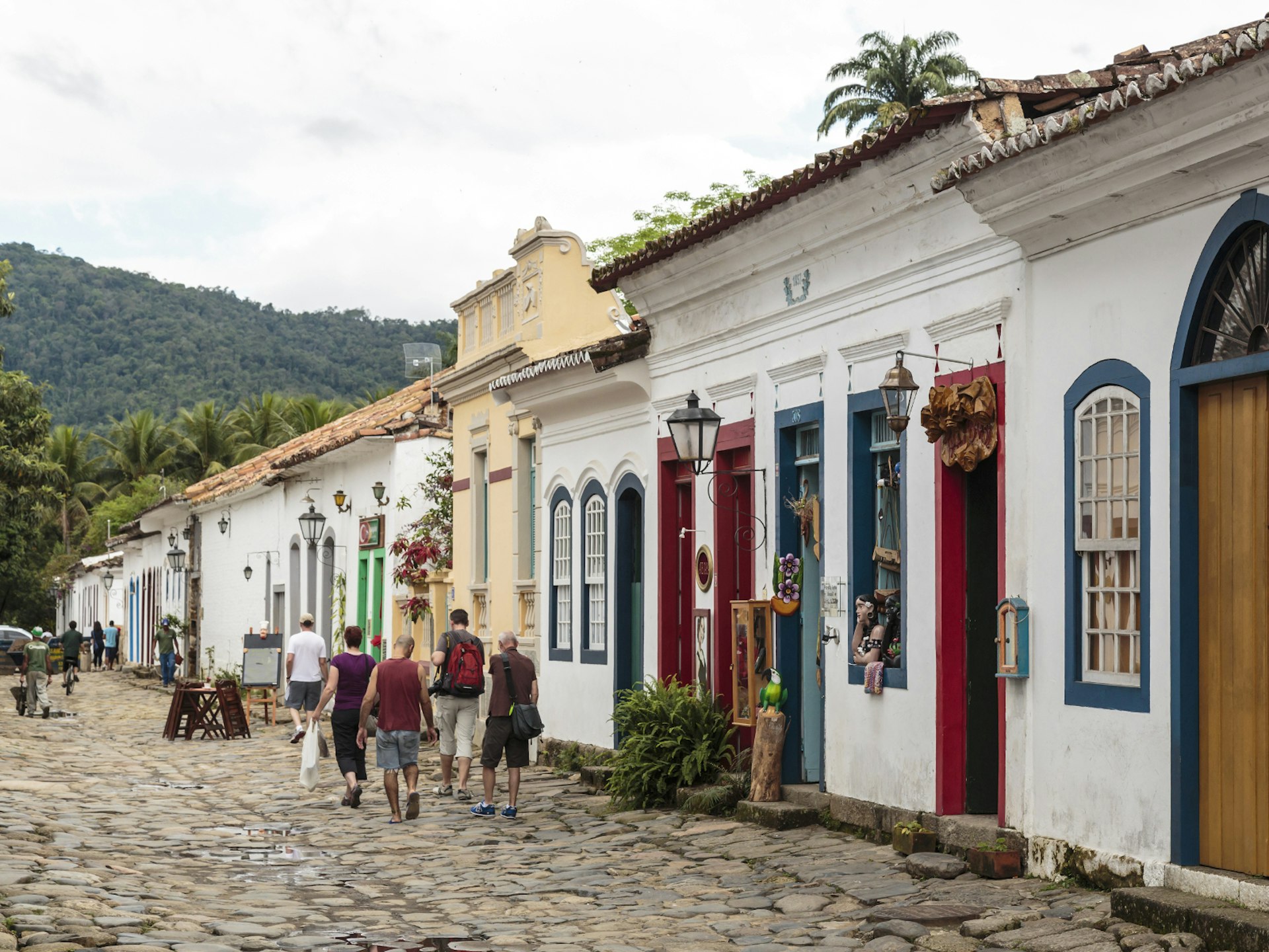 People stroll along a cobbled street in the colonial town of Paraty, Brazil