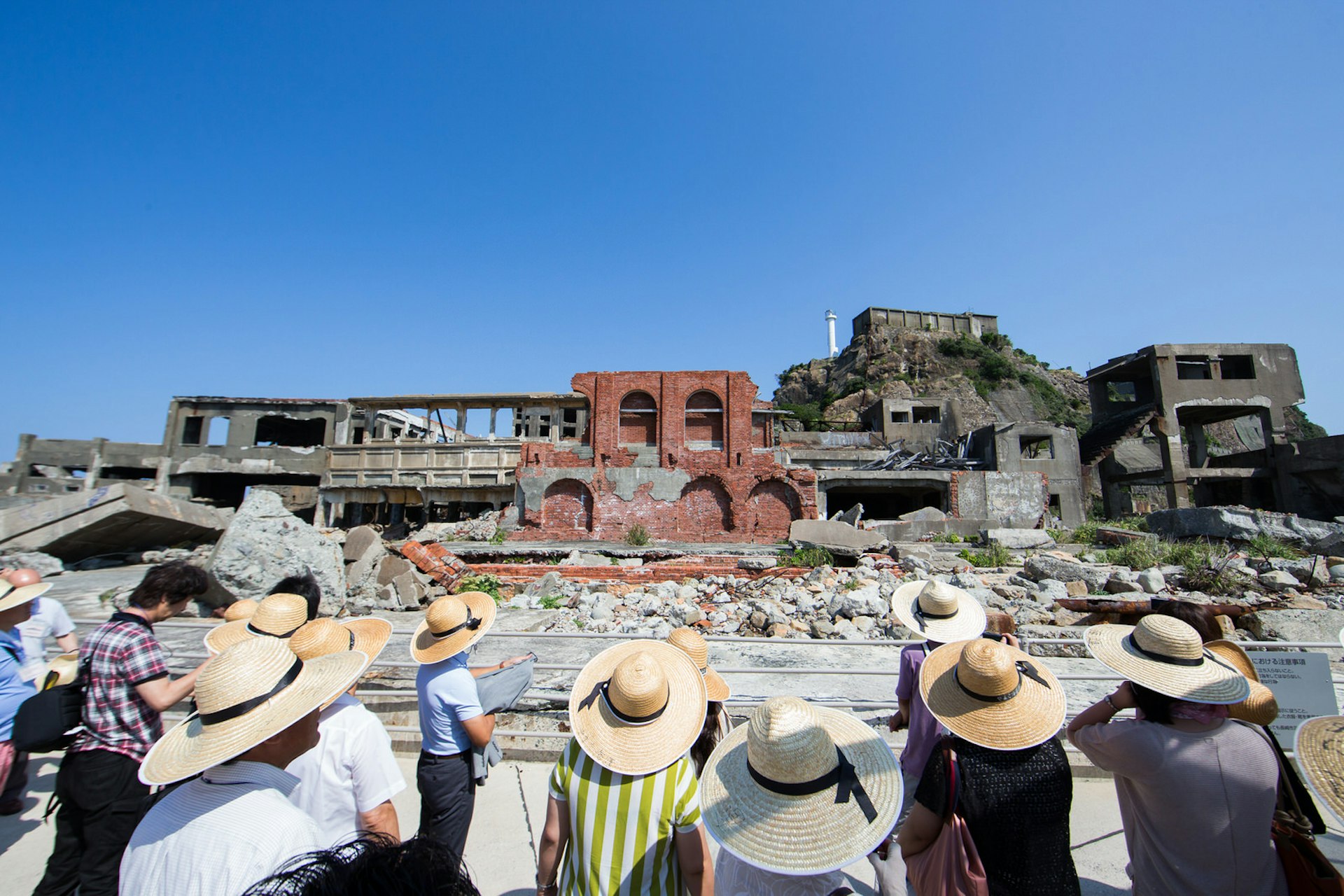 A group of tourists visiting Hashima Island off the coast of Nagasaki, Japan © Morten Falch Sortland / Getty Images