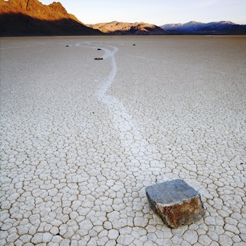 Features - Rocks move across dry lake bed leaving trails @ *Race Track* Death Valley National Park California