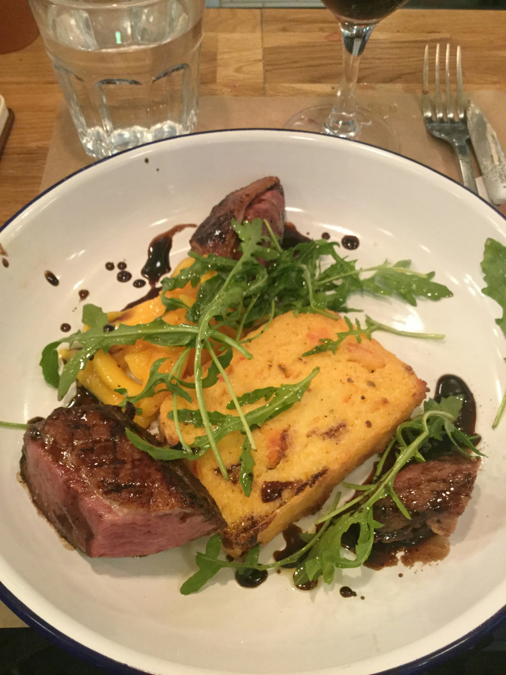 A plate of duck and mango polenta at Le Réfectoire bistro in Paris, France 