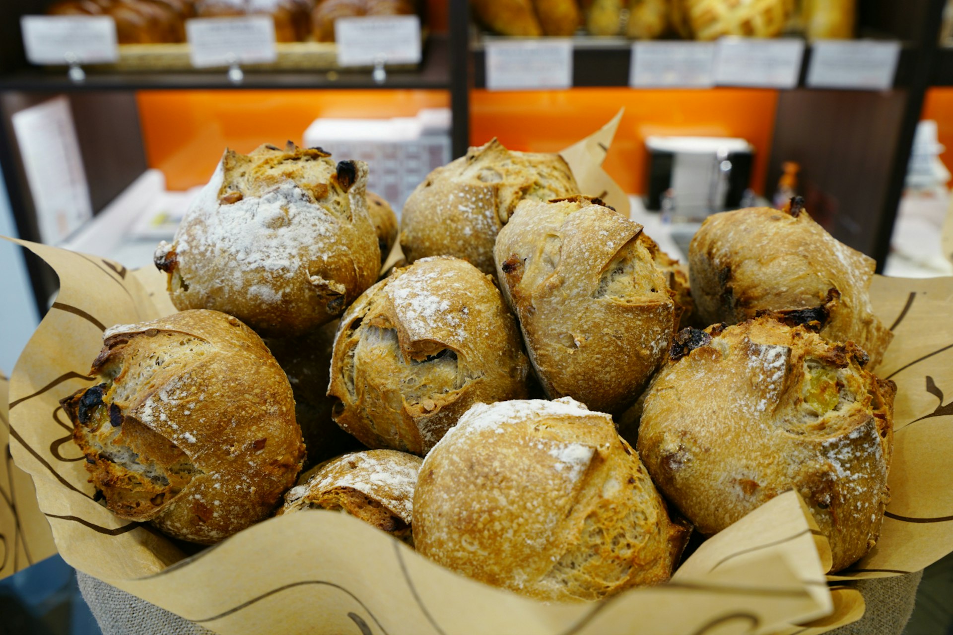 A basket of bread inside a Eric Kayser bakery 