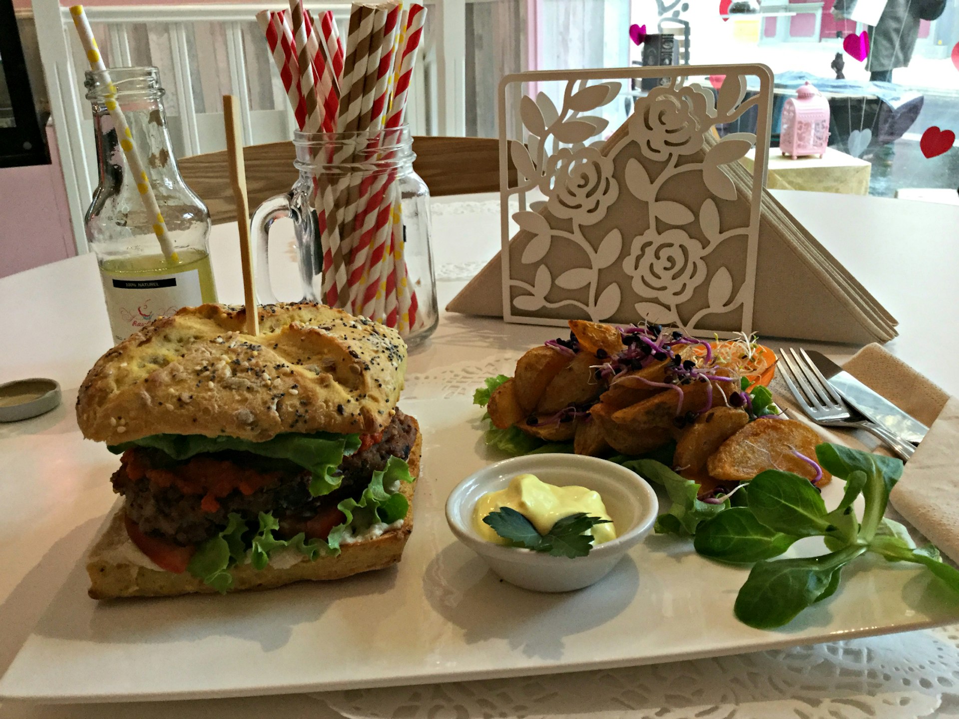 A vegan burger with homemade mayonnaise and potato wedges from RawCakes in Paris, France