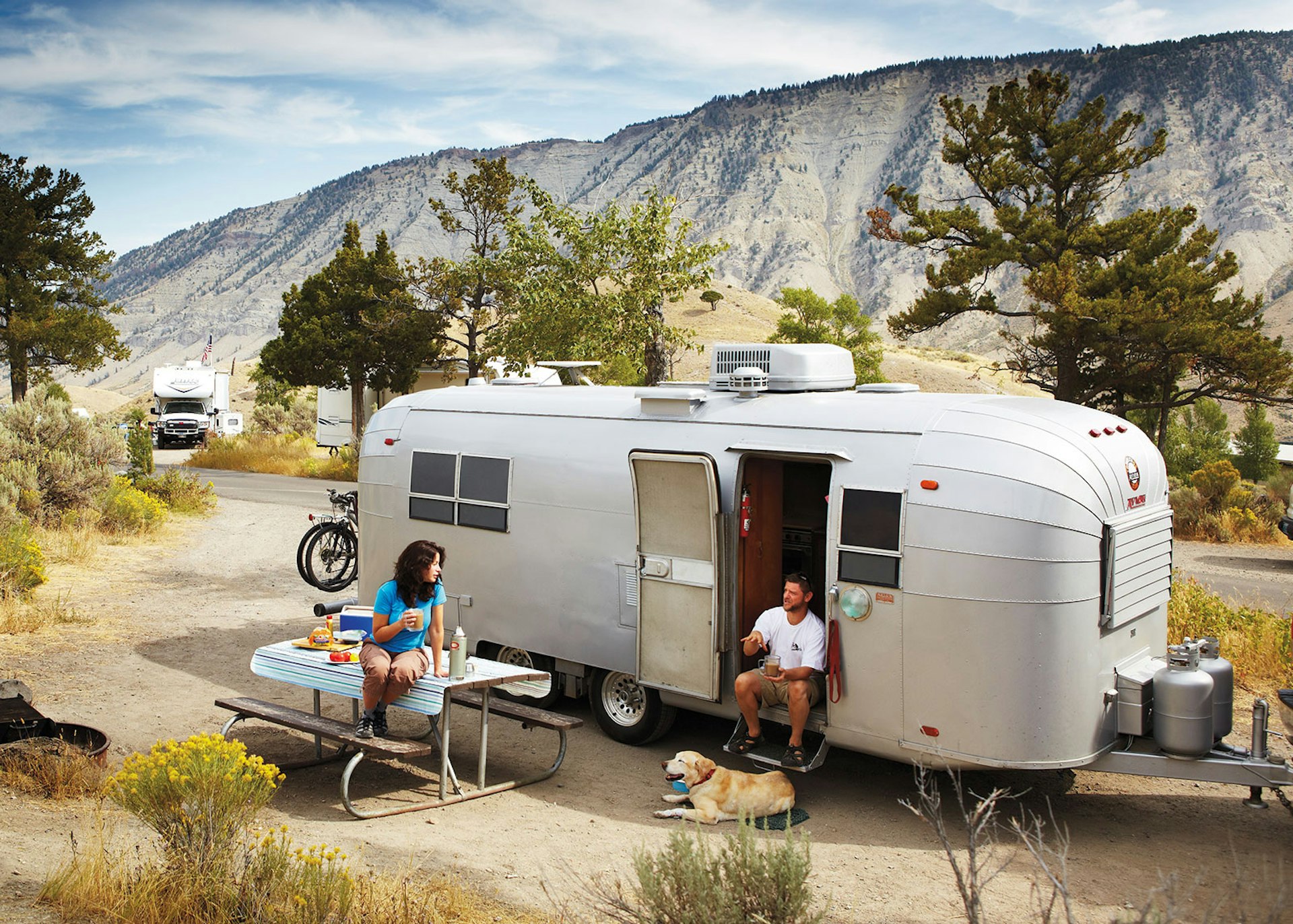 Danielle and Alex Sonsini by their restored RV at Mammoth Hot Springs in Yellowstone National Park © Matt Munro / Lonely Planet