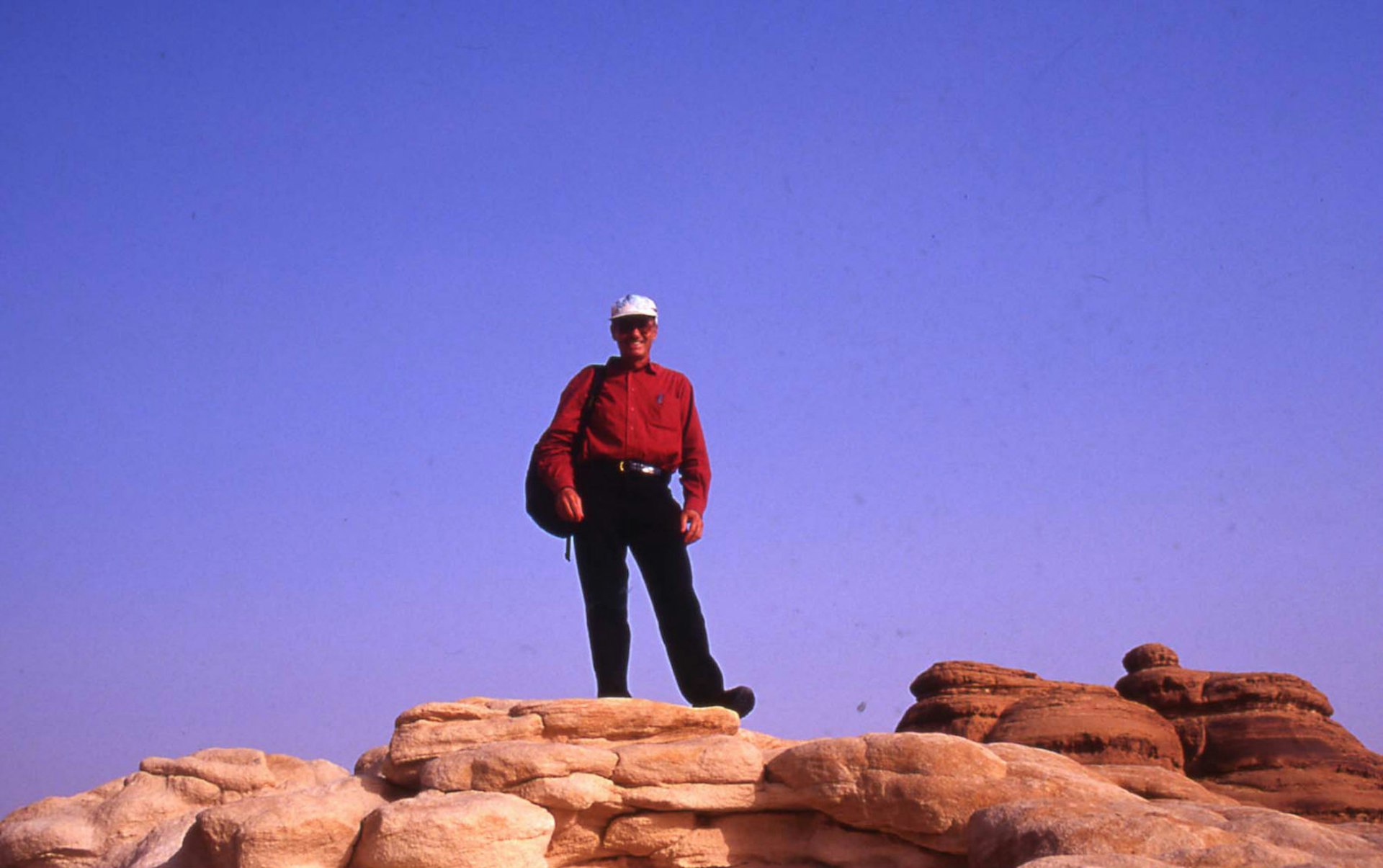 Tony Wheeler's top 10 cities - Not quite Mecca – Tony poses atop the rocky terrain of Madain Saleh © Tony Wheeler / Lonely Planet