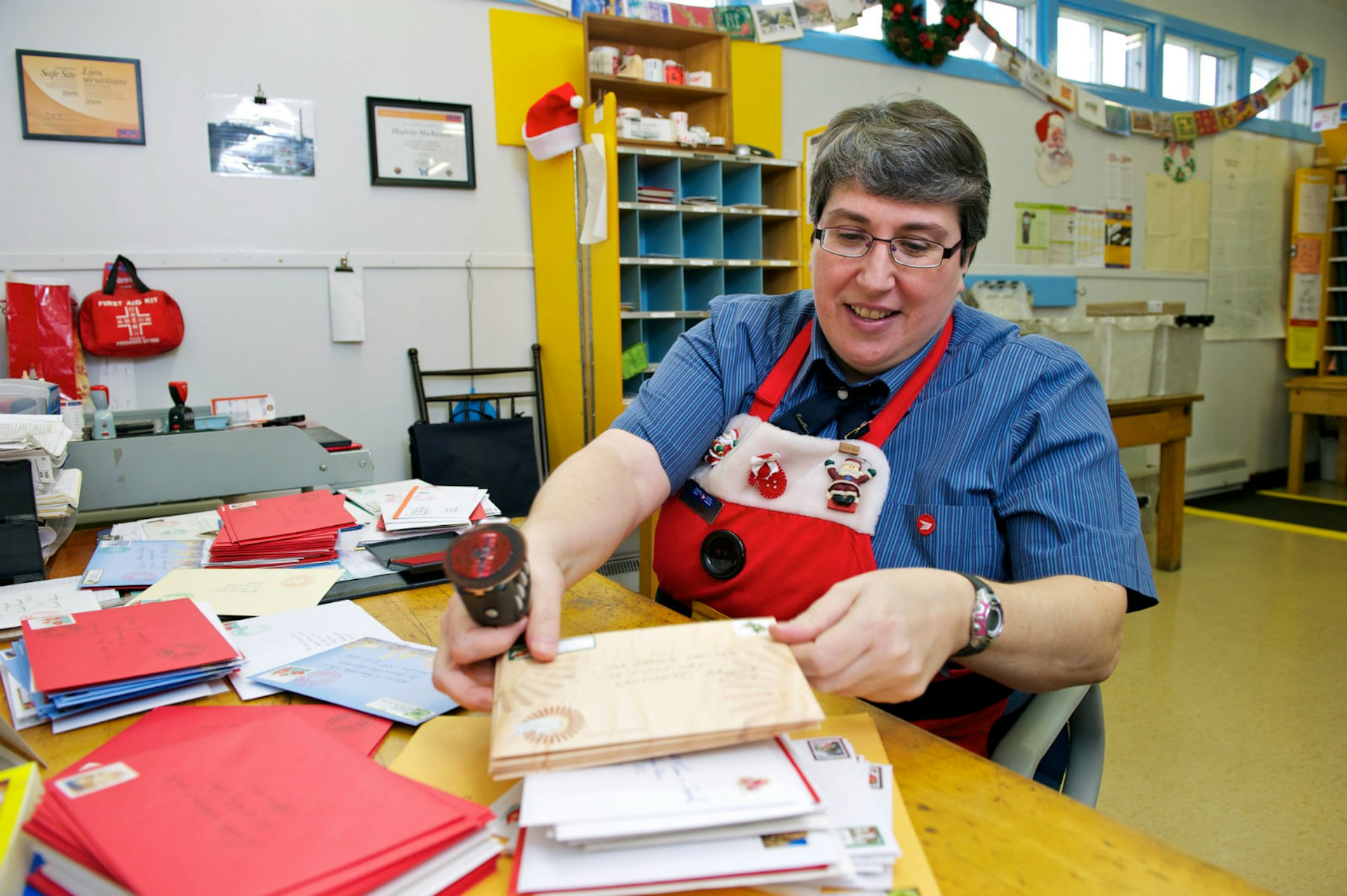 A postal worker on Christmas Island prepares to stamp the year's season's greetings © The Washington Post / Getty Images