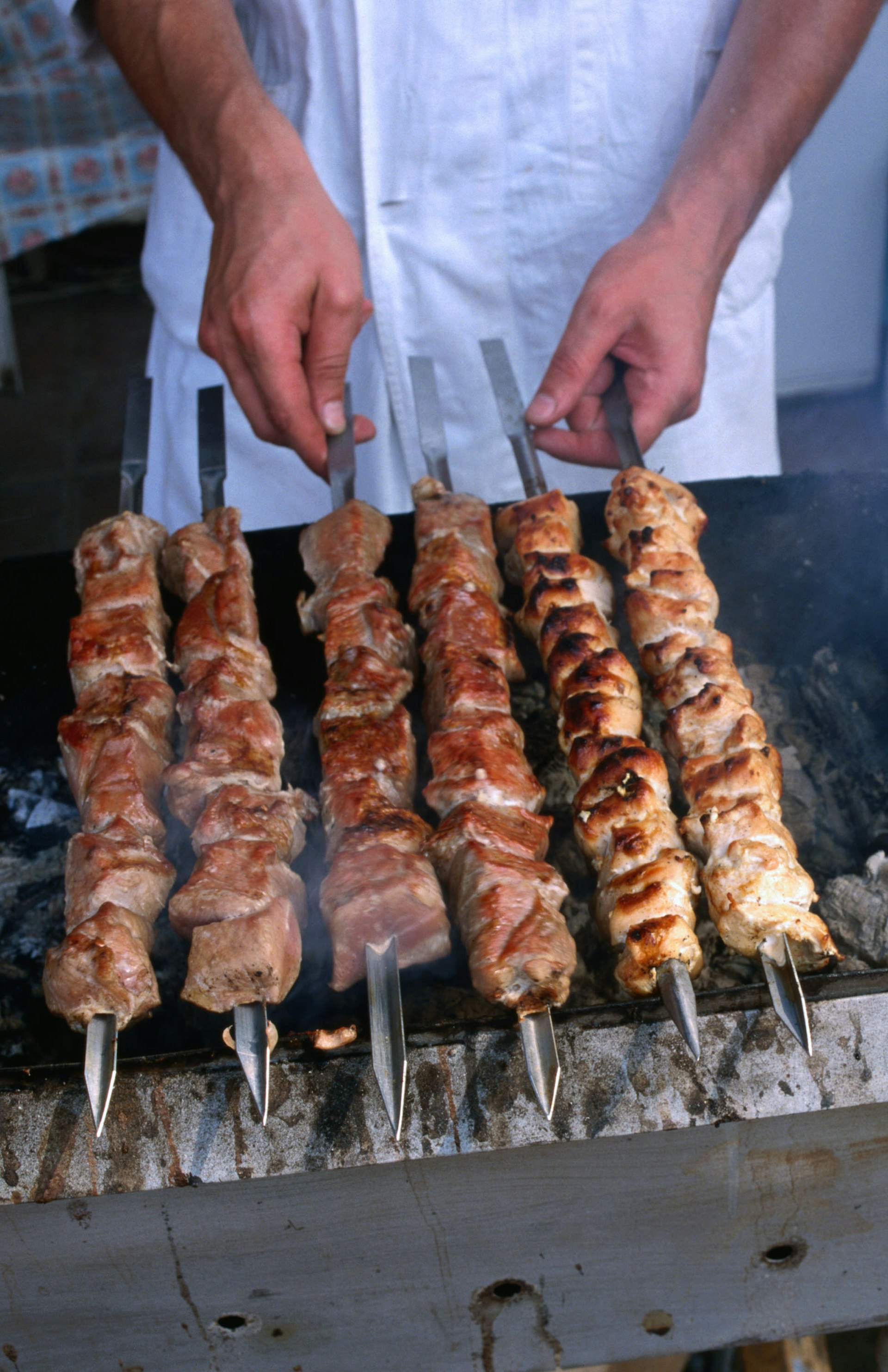Gluten-free travel: A close up of Russian kebabs smoking on a barbecue © Jonathan Smith / Getty Images