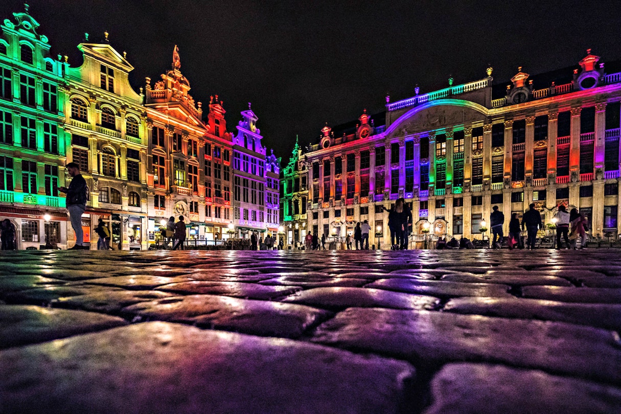 Buildings on the Grand Place in Brussels are lit up in the rainbow flag colours
