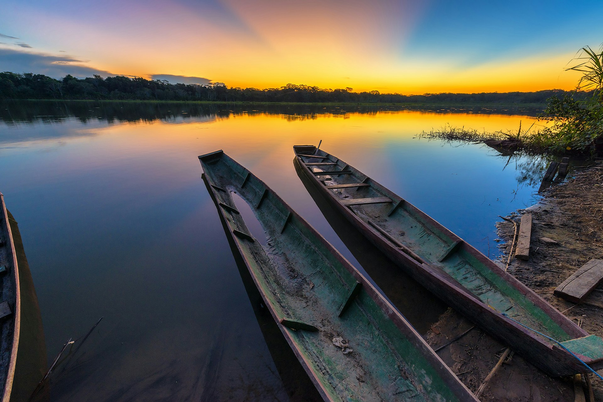 Features - Wooden Canoes Moored On Lake Against Sky During Sunset