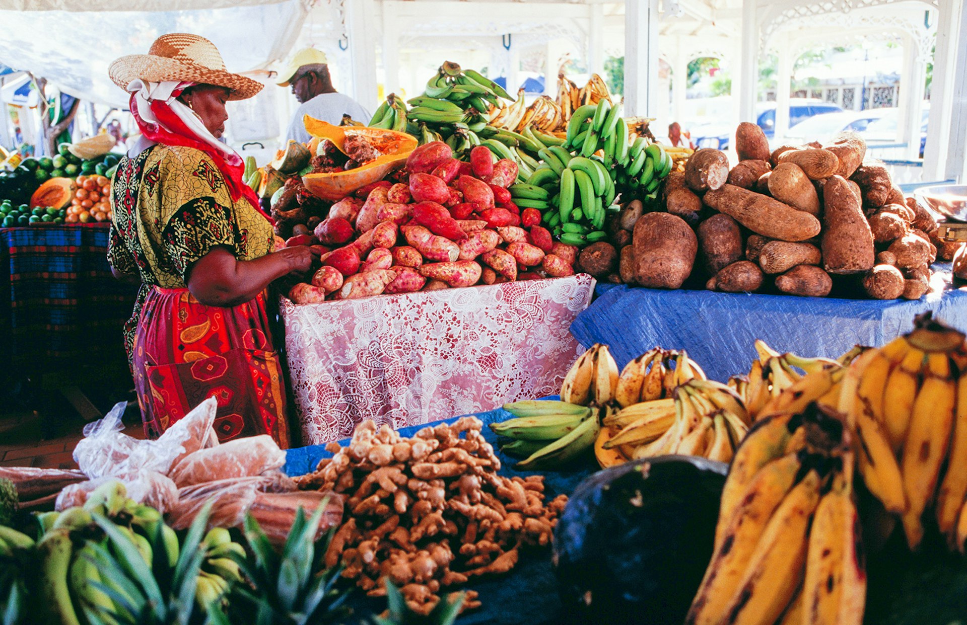 Features - Vendor at fruit &amp; vegetable stall at the public market on the waterfront.