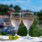 Two glasses of rosé wine served on an outdoor terrace
