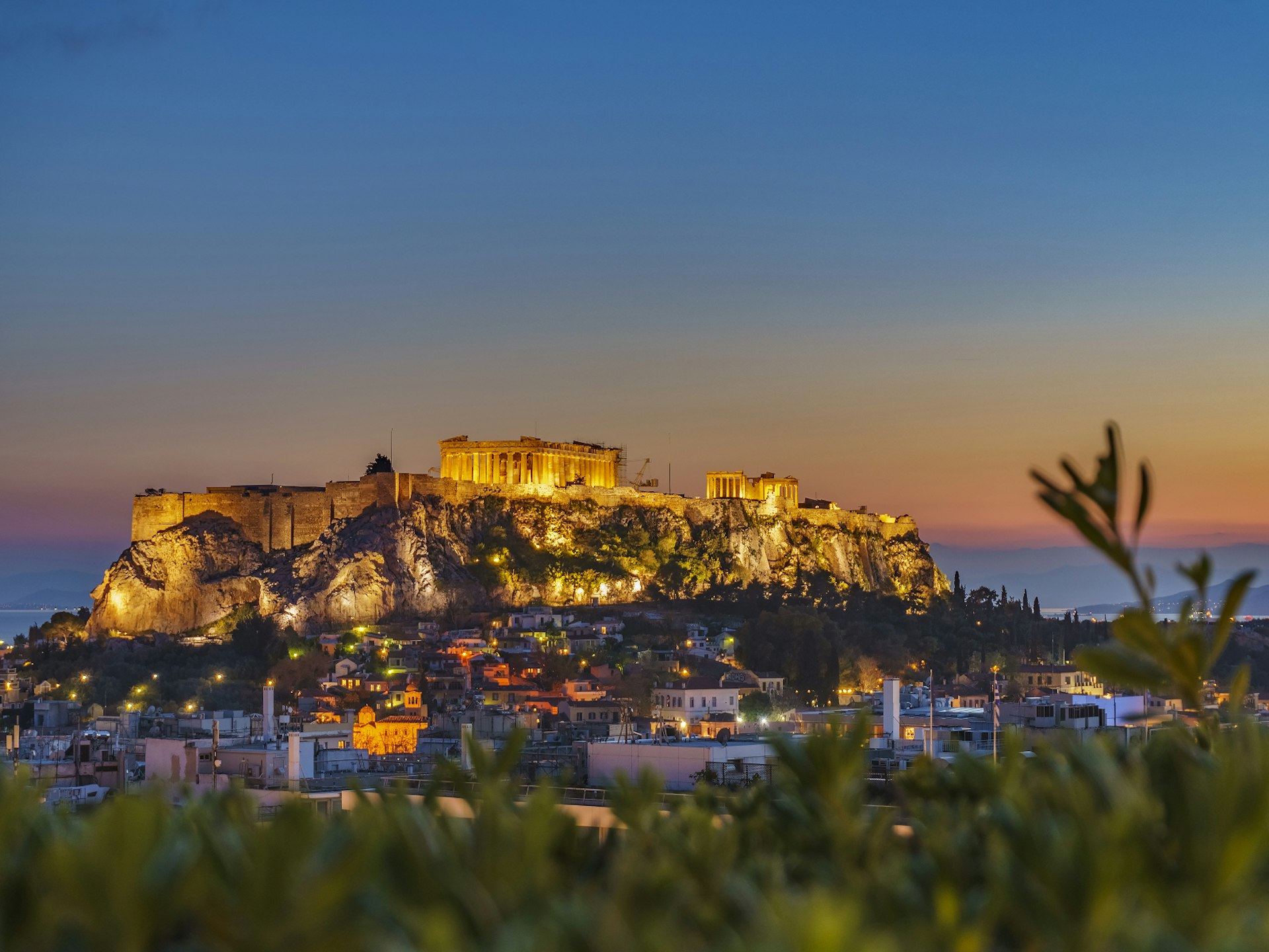  Rooftop view of the Acropolis lit up at night makes for a magnificent dinner setting © Kotsovolos Panagiotis / Shutterstock