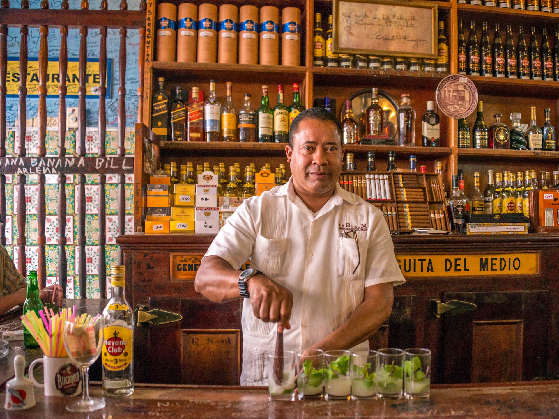 A waiter at La Bodeguita del Medio bar in Cuba makes a batch of mojitos