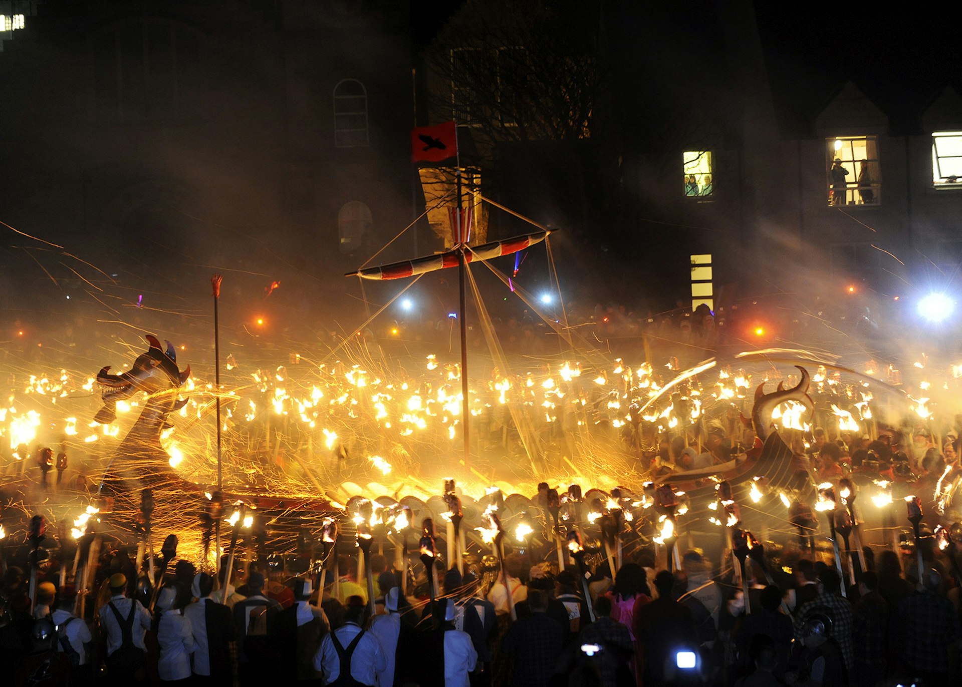 A crowd gathered around a burning Viking longship at Shetland's Up Helly Aa festival © Andy Buchanan / Getty Images