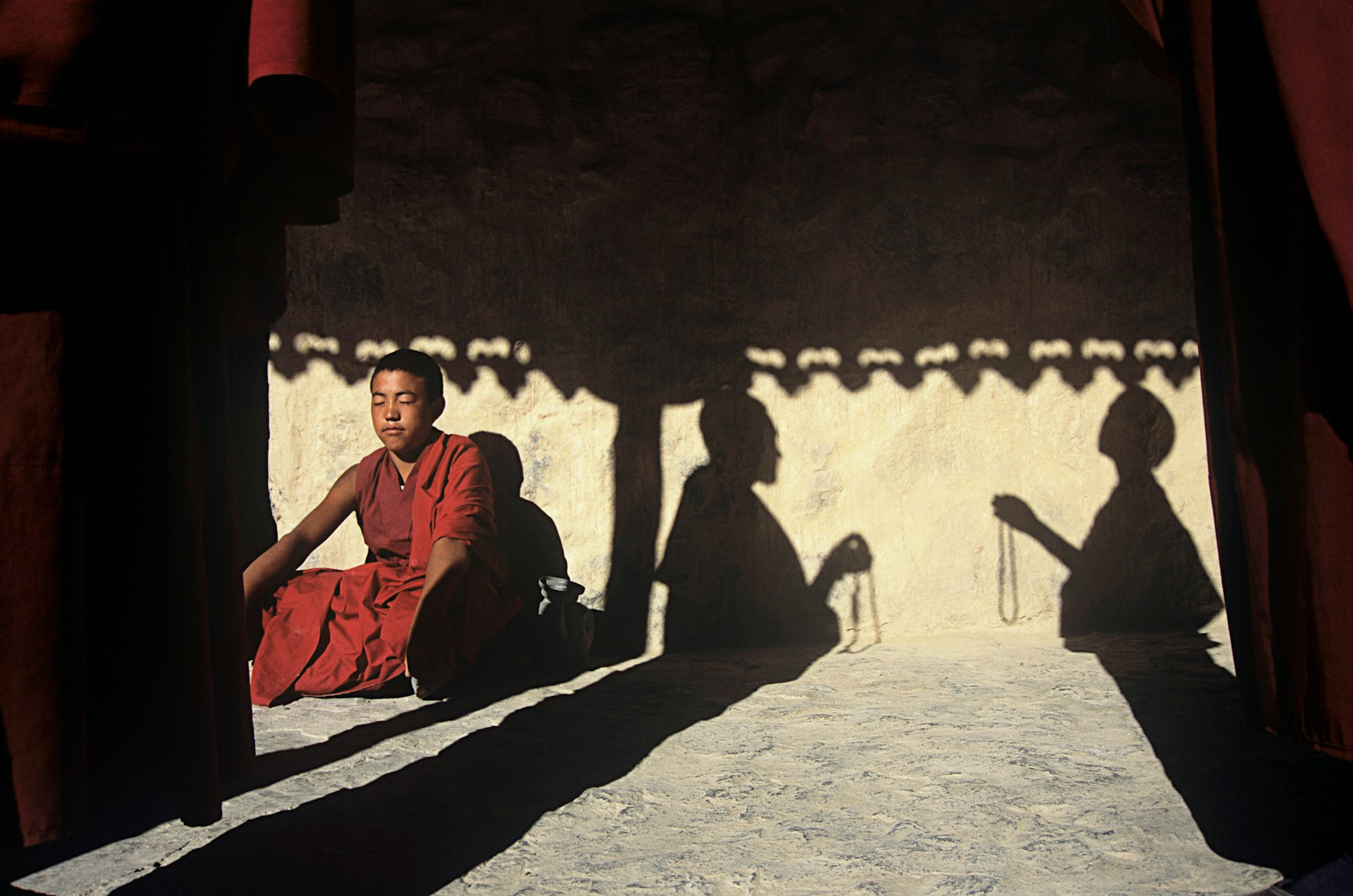 Monks meditate in bright sunshine at Tabo Gompa