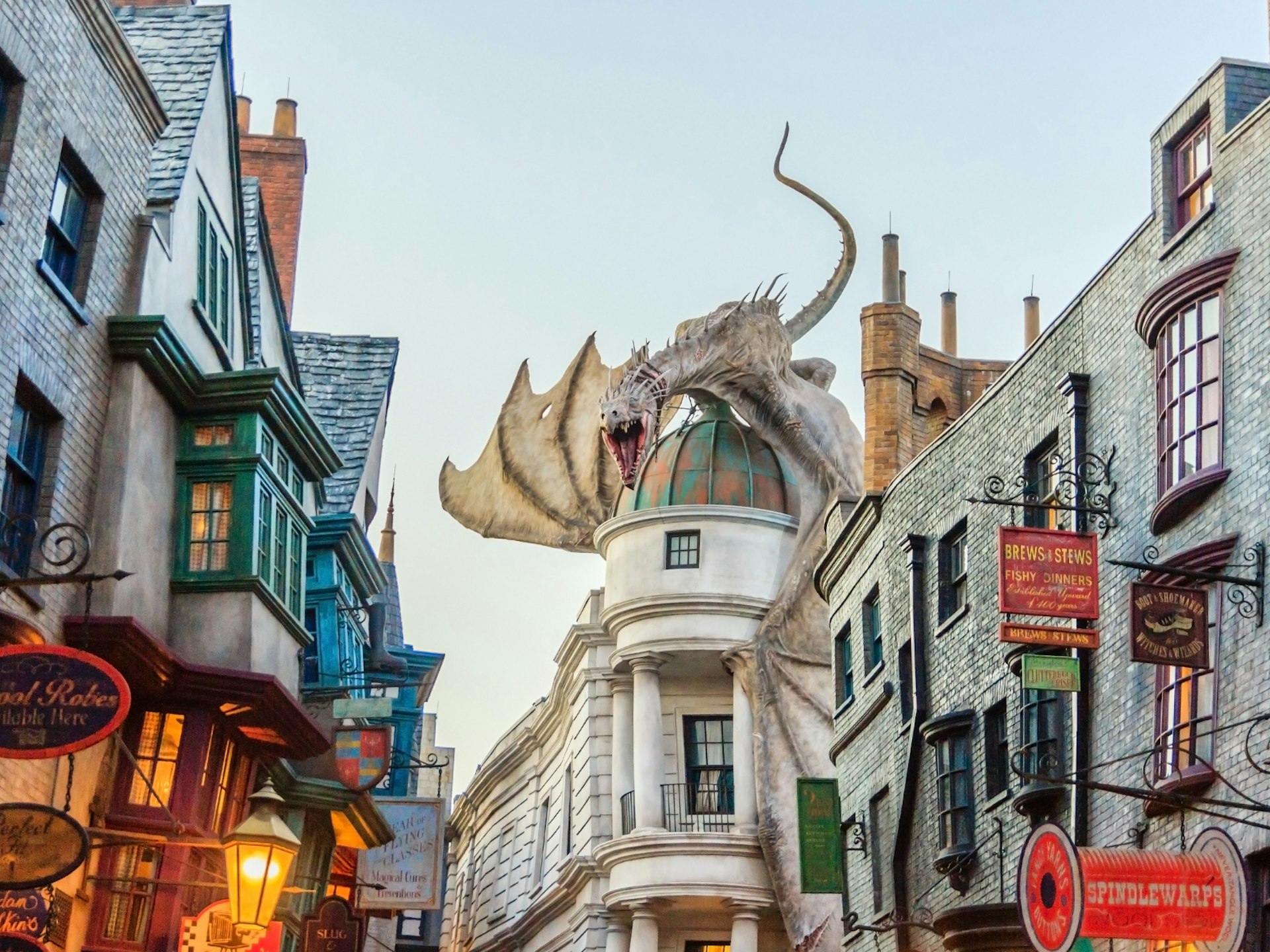 A dragon sits on the roof of a domed roof of Gringotts Banks at The Wizarding World of Harry Potter set at Universal Studios, Florida