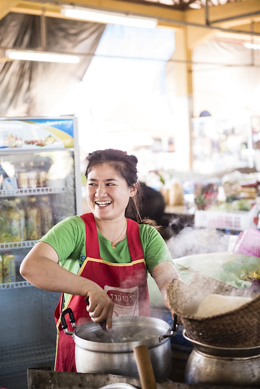 Features - Market, Bolaven Plateau, Laos Mrs Nang serves her speciality, khao poon, or noodle soup, in the market at Paksong