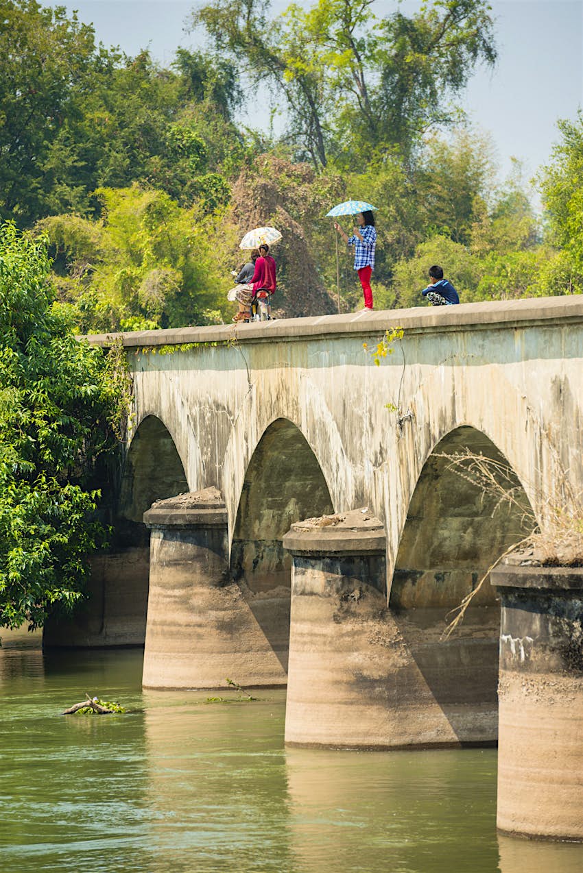 Features - 4000 Islands, Laos Locals cross the bridge between the islands of Don Det and Don Khon