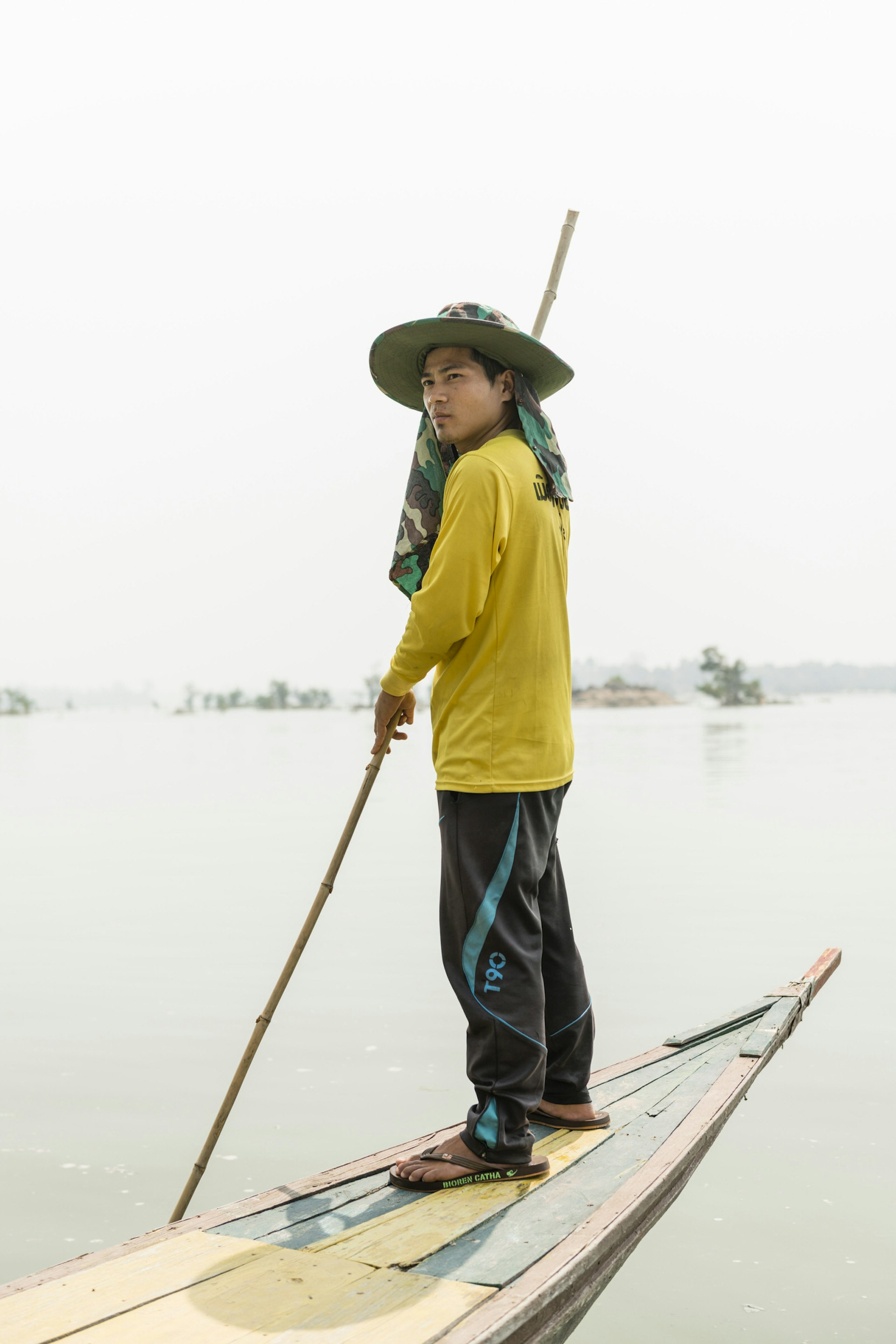 Mr Jong guides himself through the shallows of the Mekong on his boat 