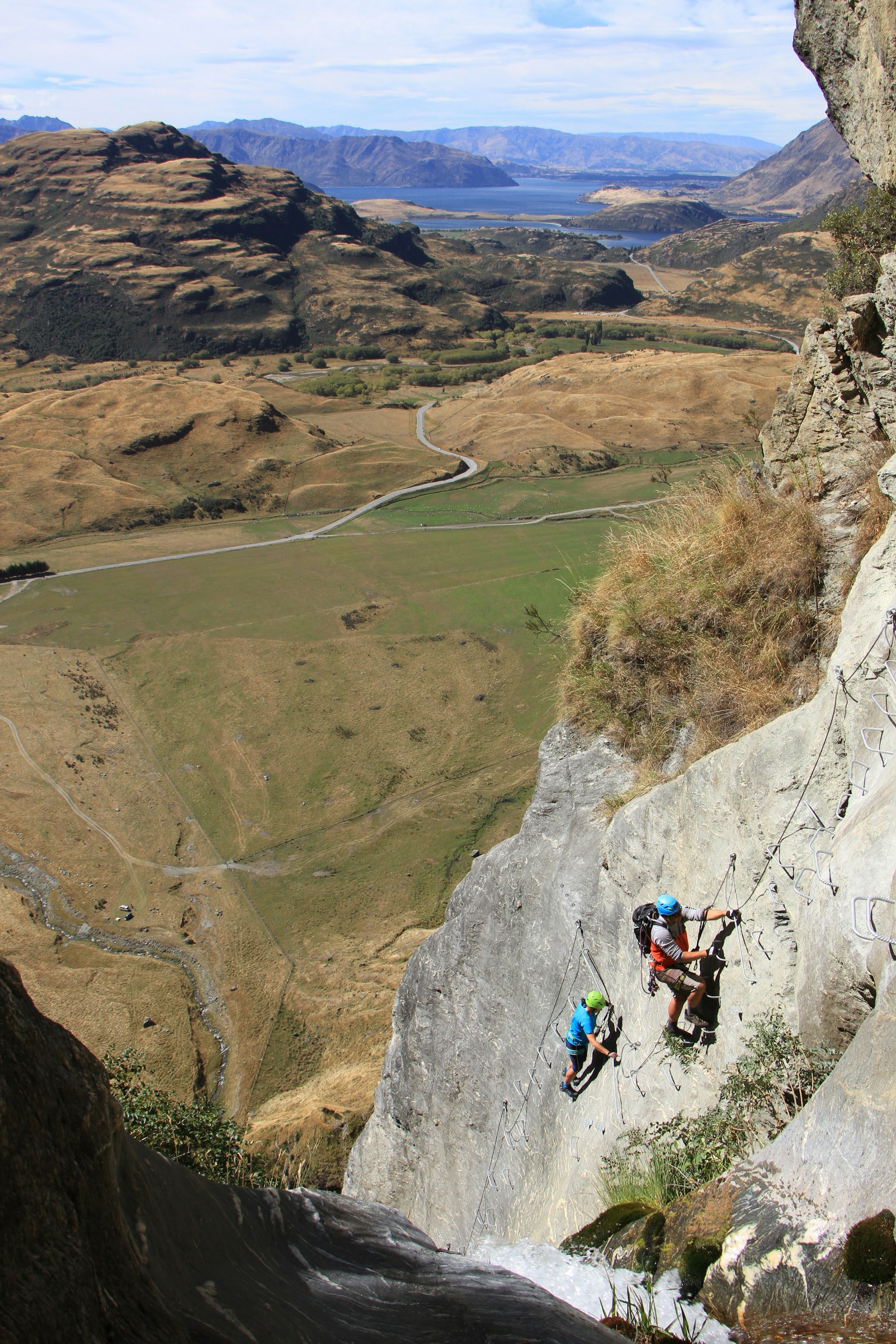 Two climbers ascending a via ferrata alongside the Twin Falls, Wanaka, New Zealand