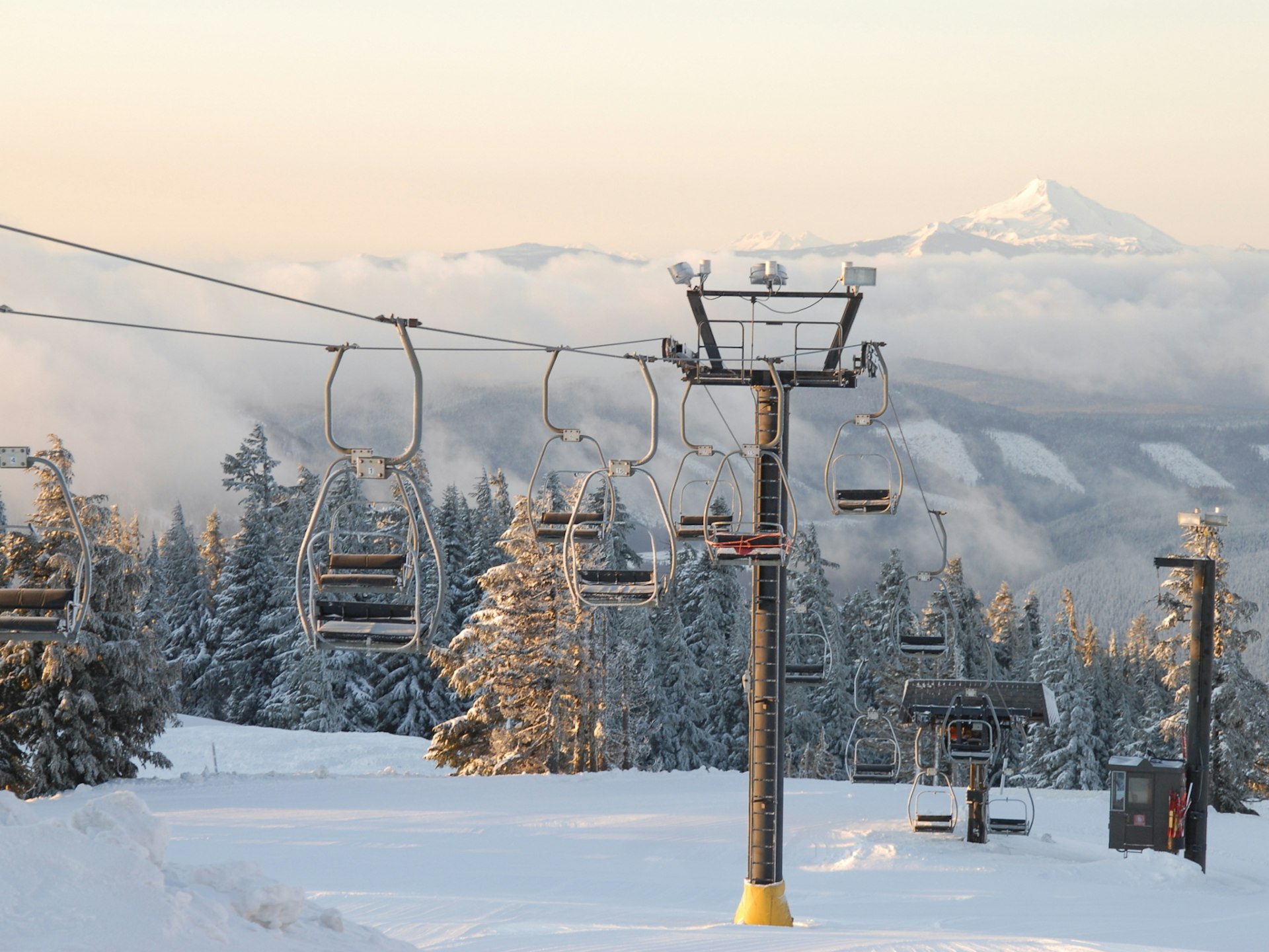 A ski lift going through the snowy scenery of Mt Hood's Timberline ski area, Oregon