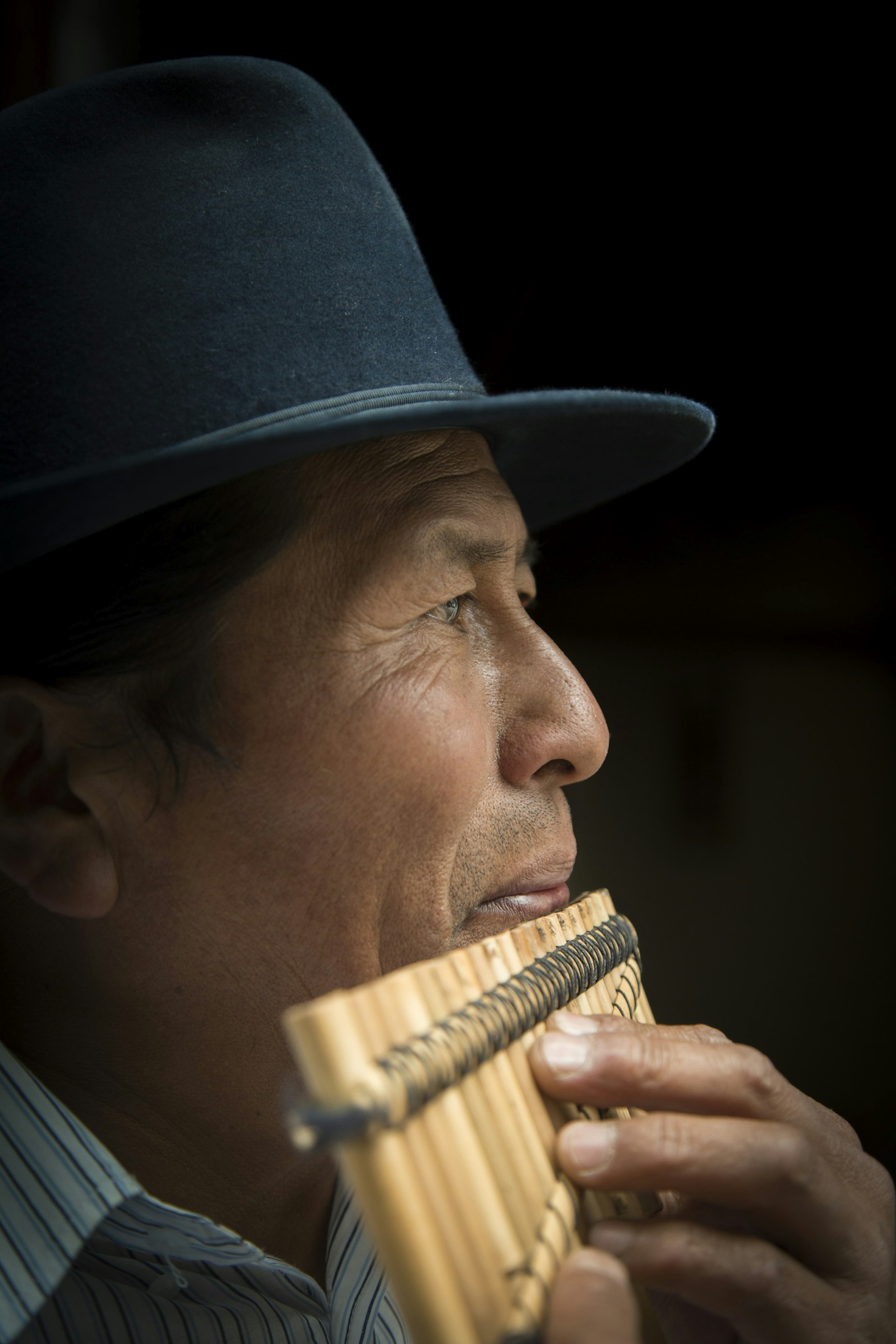 Jose Luis Fichamba plays a rondador, recently made from bamboo in his workshop © Philip Lee Harvey / Lonely Planet